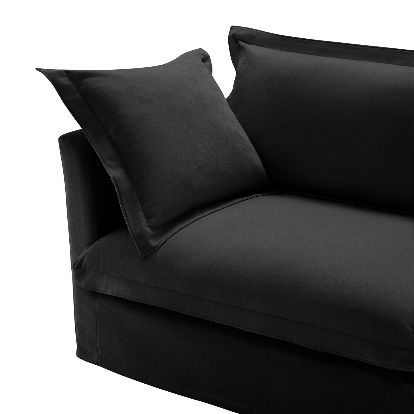 Detail view of the end of a fluffy black chenille sectional sofa — highlighting the plush armrest, deep cushion, and soft, textured fabric with removable, washable slipcovers for a cozy, pet-friendly touch.