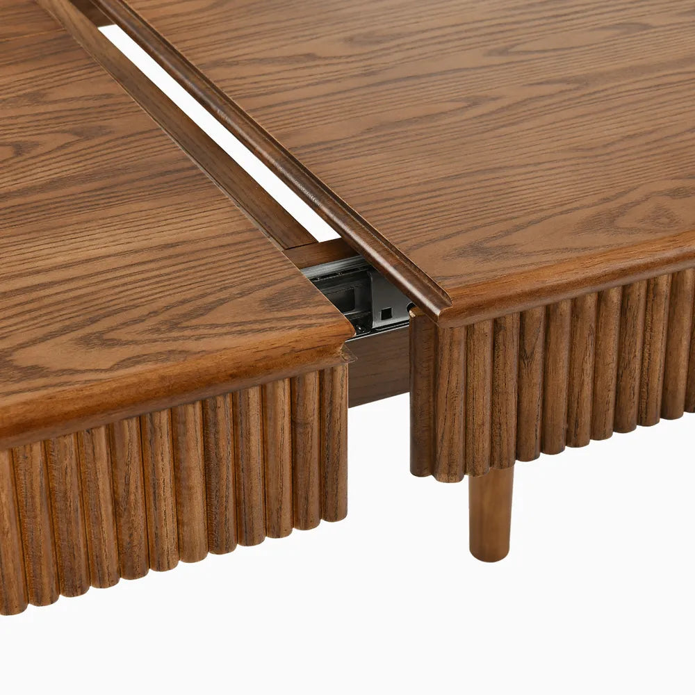 Close-up of interior extension mechanism on ash wood dining table, showcasing smooth sliding track and durable craftsmanship.