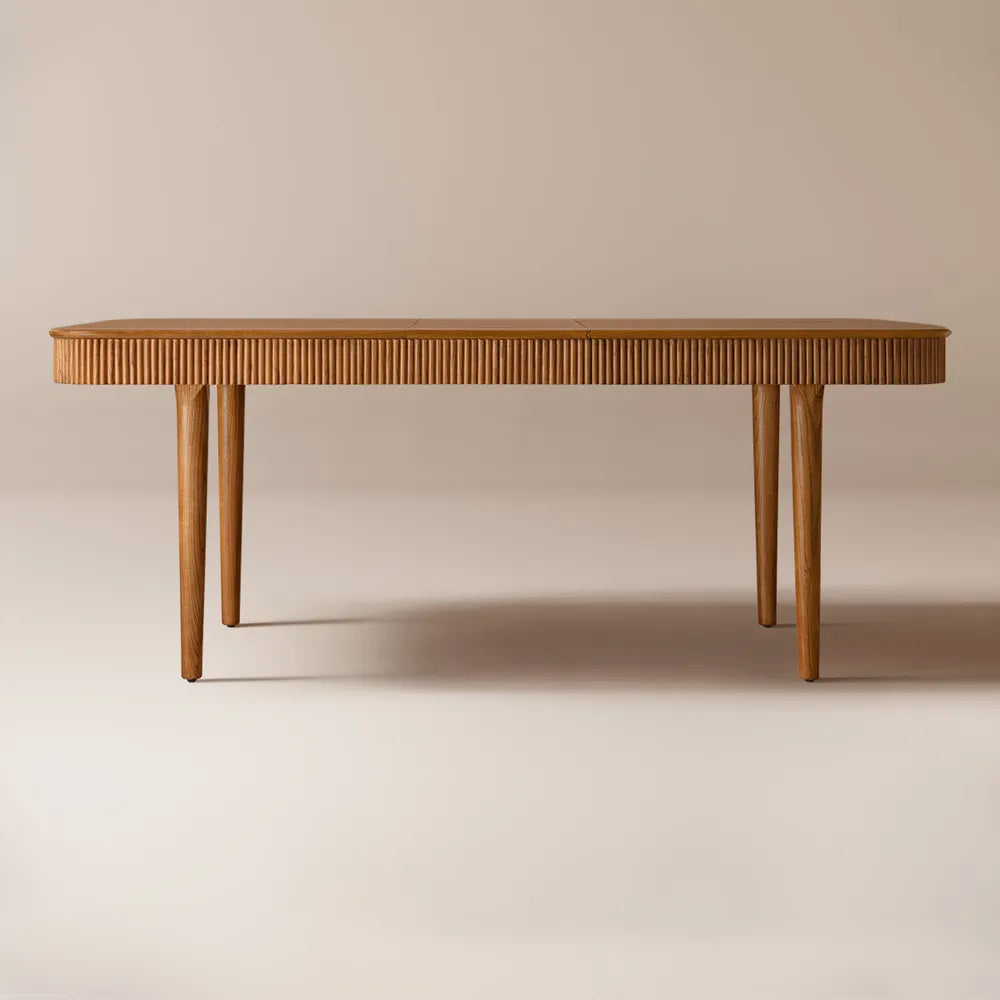Modern rectangular dining table made of solid ash wood with fluted detailing and warm brown finish. Extends from 63 to 78 inches to seat 4–6 guests. A space-saving, mid-century inspired design perfect for everyday dining and larger gatherings.