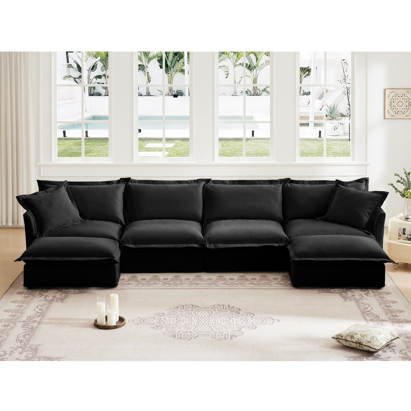 Fluffy 4-seat black chenille sectional styled in a modern living room, with two ottomans creating an inviting L shape — soft texture, deep seats, and plush slipcovered cushions for a cozy, pet-friendly home.