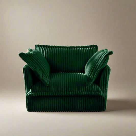 studio shot of the fluffy chair sofa in emerald corduory showing the plush pillows rich color and comfortable deep wide seat