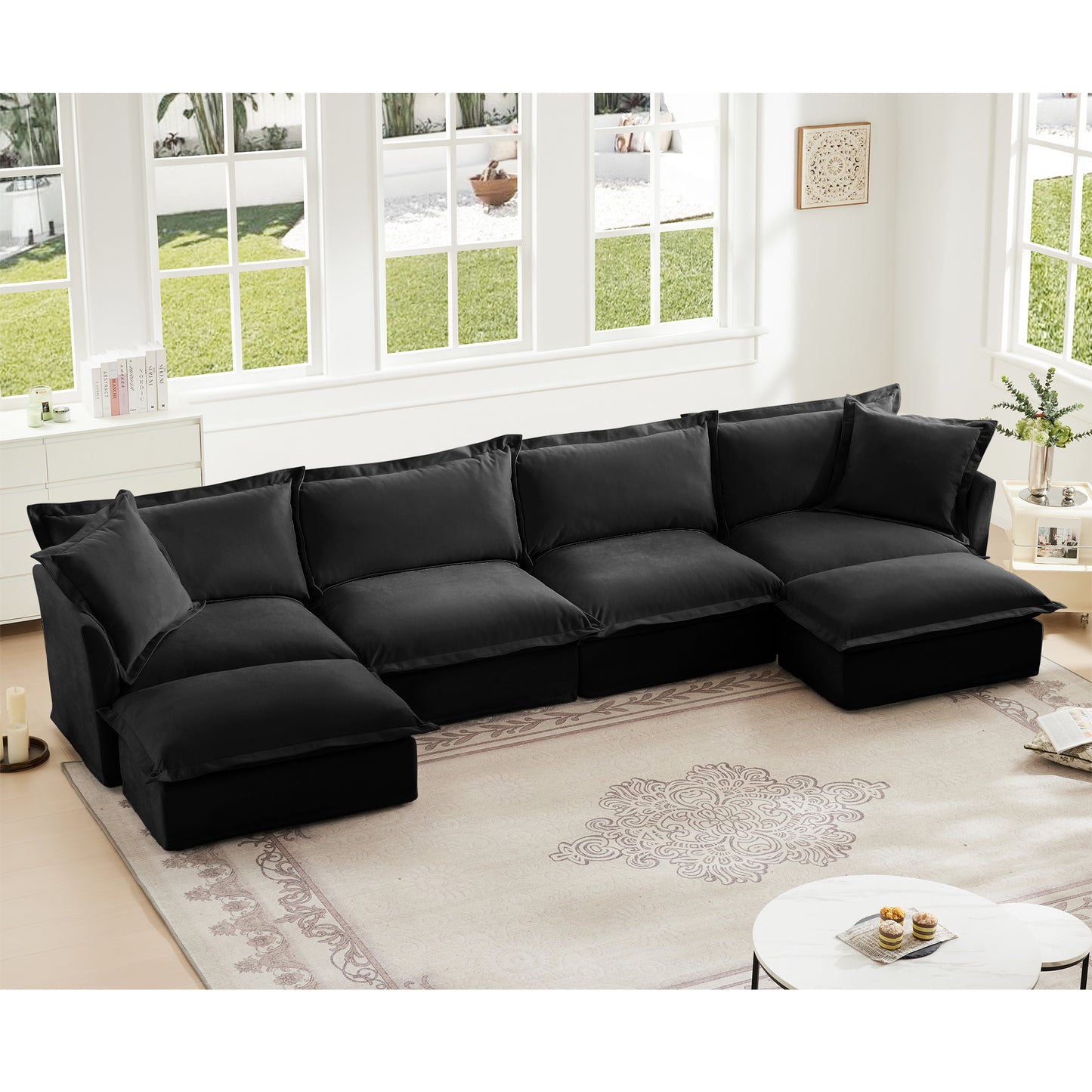 Fluffy black chenille sectional with two ottomans styled in a warm, inviting living room — highlights plush texture, deep seating, and modular versatility with removable, pet-friendly slipcovers.