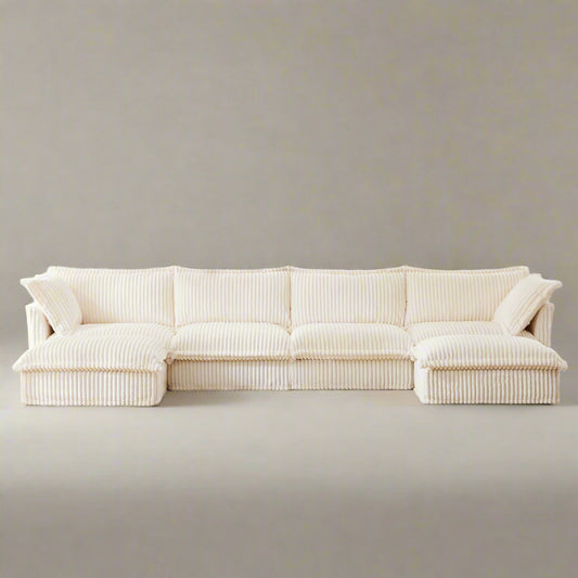 Fluffy 4-seat cream corduroy sectional sofa with two ottomans — featuring ribbed, textured fabric, deep modular seating, and removable, machine washable slipcovers. This pet-friendly couch offers versatile L or U shaped layouts and plush comfort in a modern, cozy design.