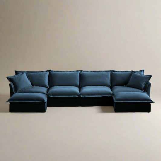 Angled view of a navy blue 4-seat chenille sectional sofa with two ottomans, showcasing its modular L-shaped layout, plush deep seats, and removable, machine washable slipcovers.