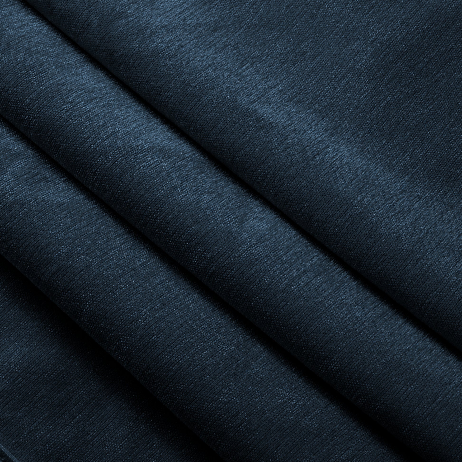 Close-up shot of the navy chenille fabric on the sectional, emphasizing the soft, textured weave and plush, cozy feel of the machine washable material.