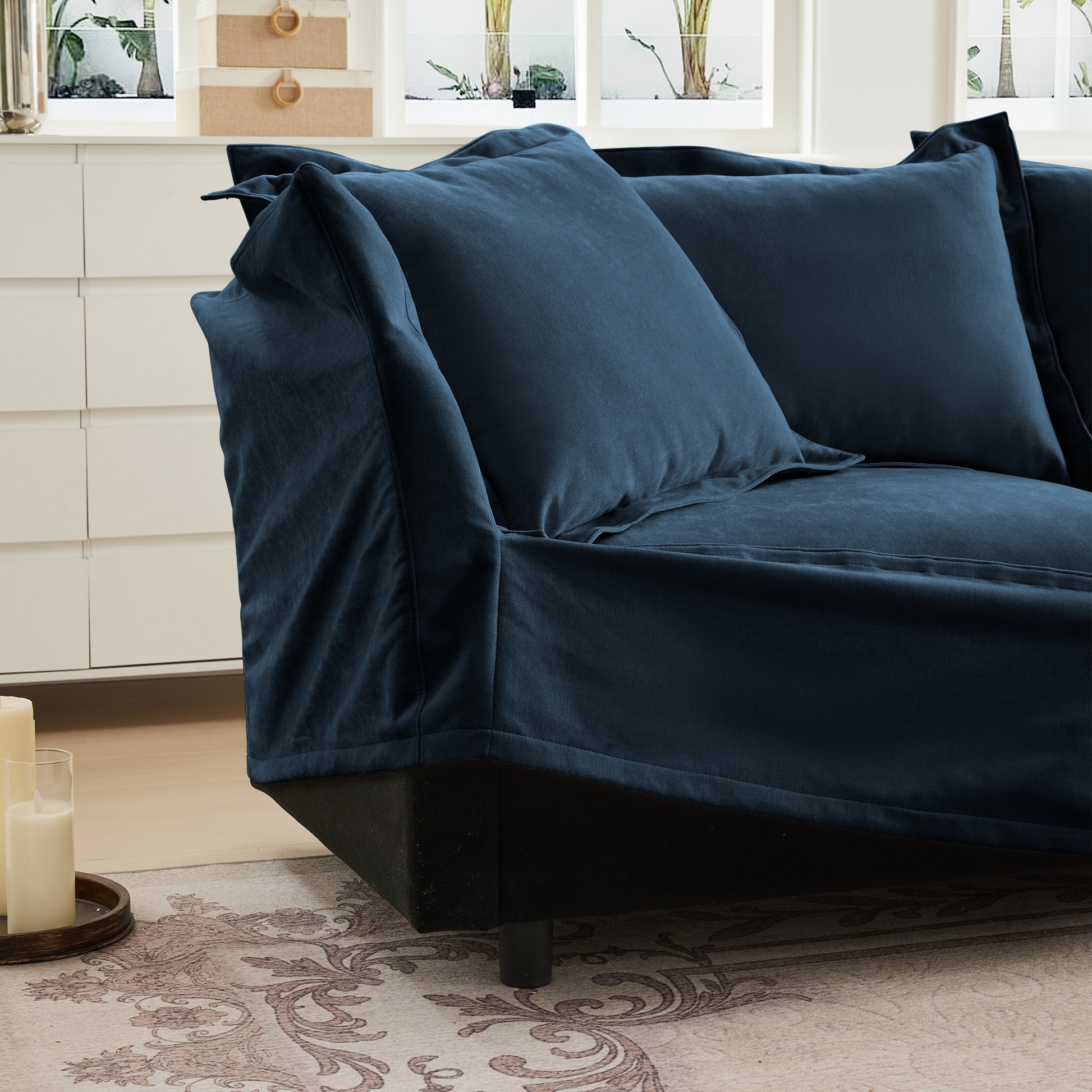 Detailed view of the navy chenille sectional with slipcover being removed, emphasizing its pet-friendly, machine washable design ideal for homes with pets.