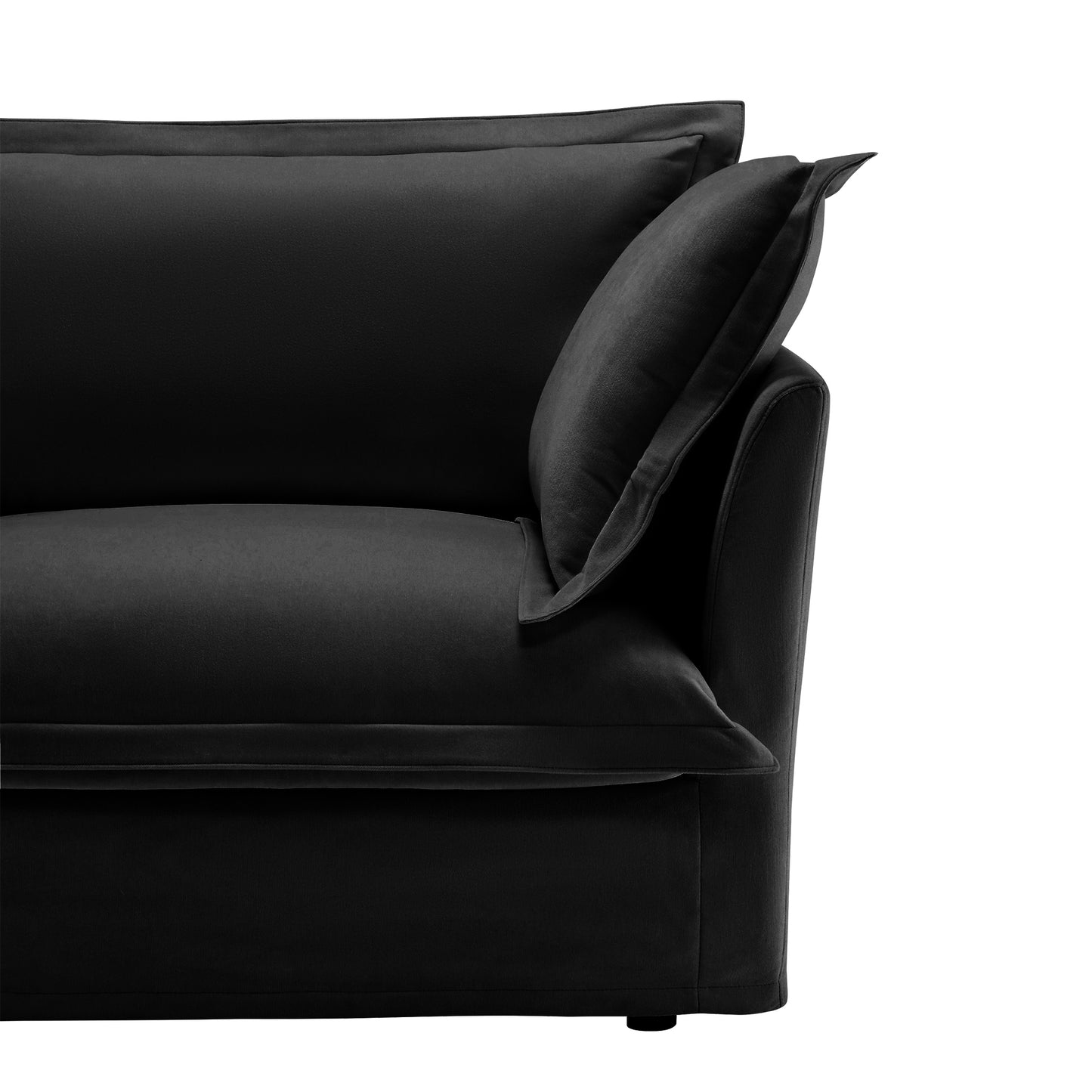 Frontal close-up of the end of a fluffy black chenille sectional — featuring a textured armrest, plush seat cushion, and soft, removable slipcover that adds both comfort and pet-friendly practicality.