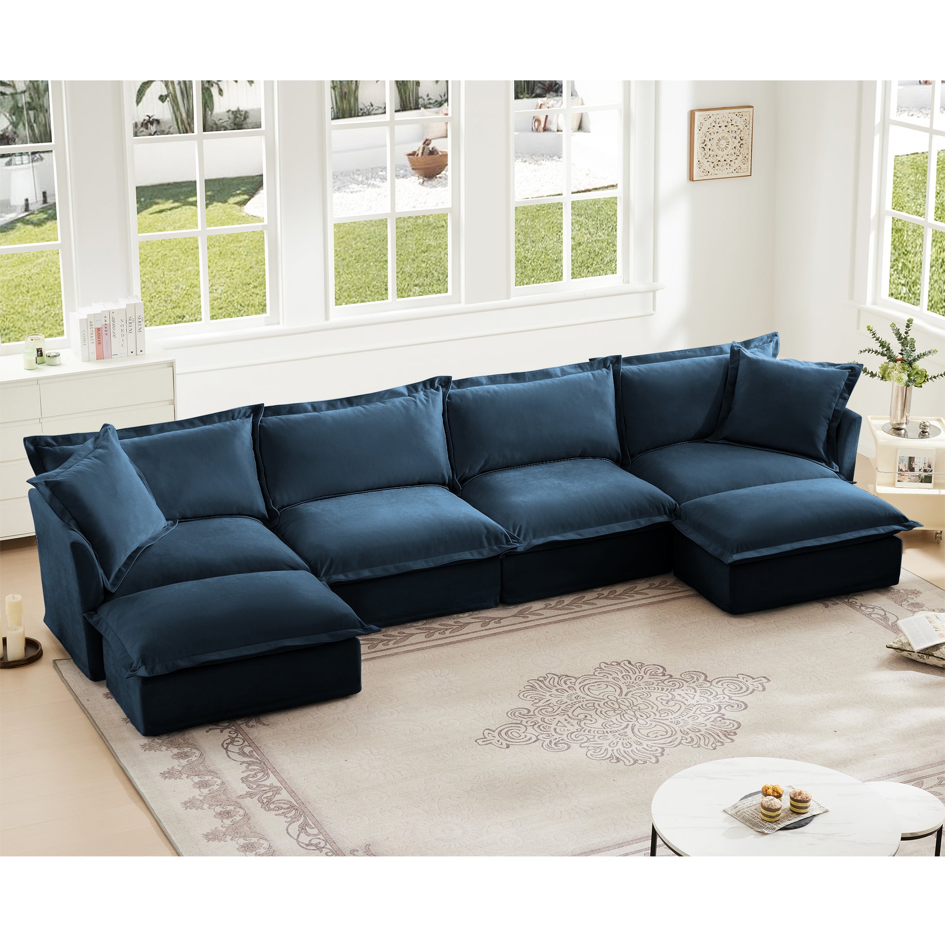 Cozy living room setup featuring a navy chenille 4-seat sectional with two ottomans, arranged in a U-shape, emphasizing its plush texture, deep seating, and removable slipcovers in a real home environment.