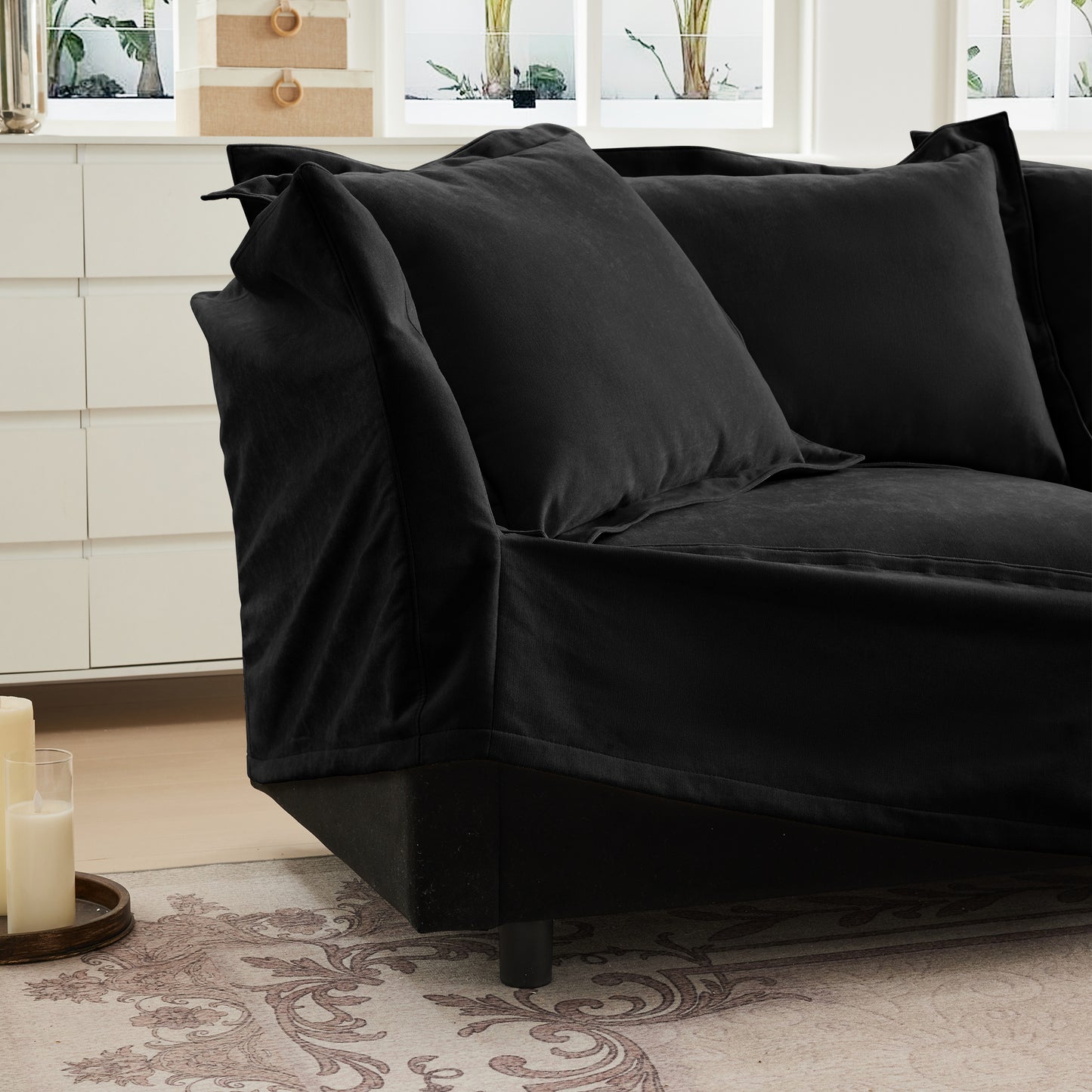 Detail shot showing the removable, machine washable slipcover on a fluffy black chenille sectional — emphasizing its pet-friendly design, easy maintenance, and durable, soft fabric perfect for everyday living.