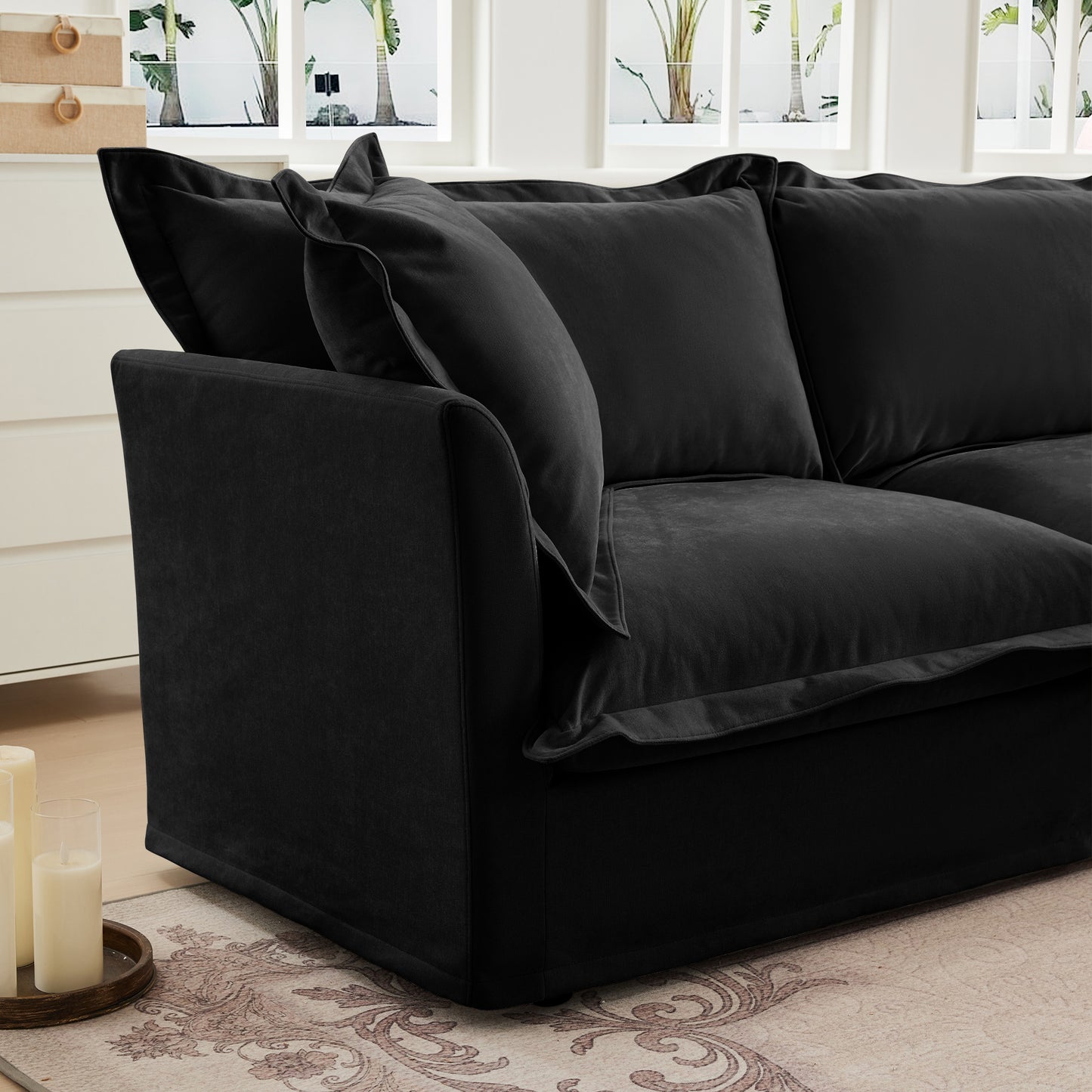 Side shot of a fluffy black chenille sectional sofa — highlighting the plush armrest, deep seating, and soft, textured slipcovers designed for comfort and easy cleaning.