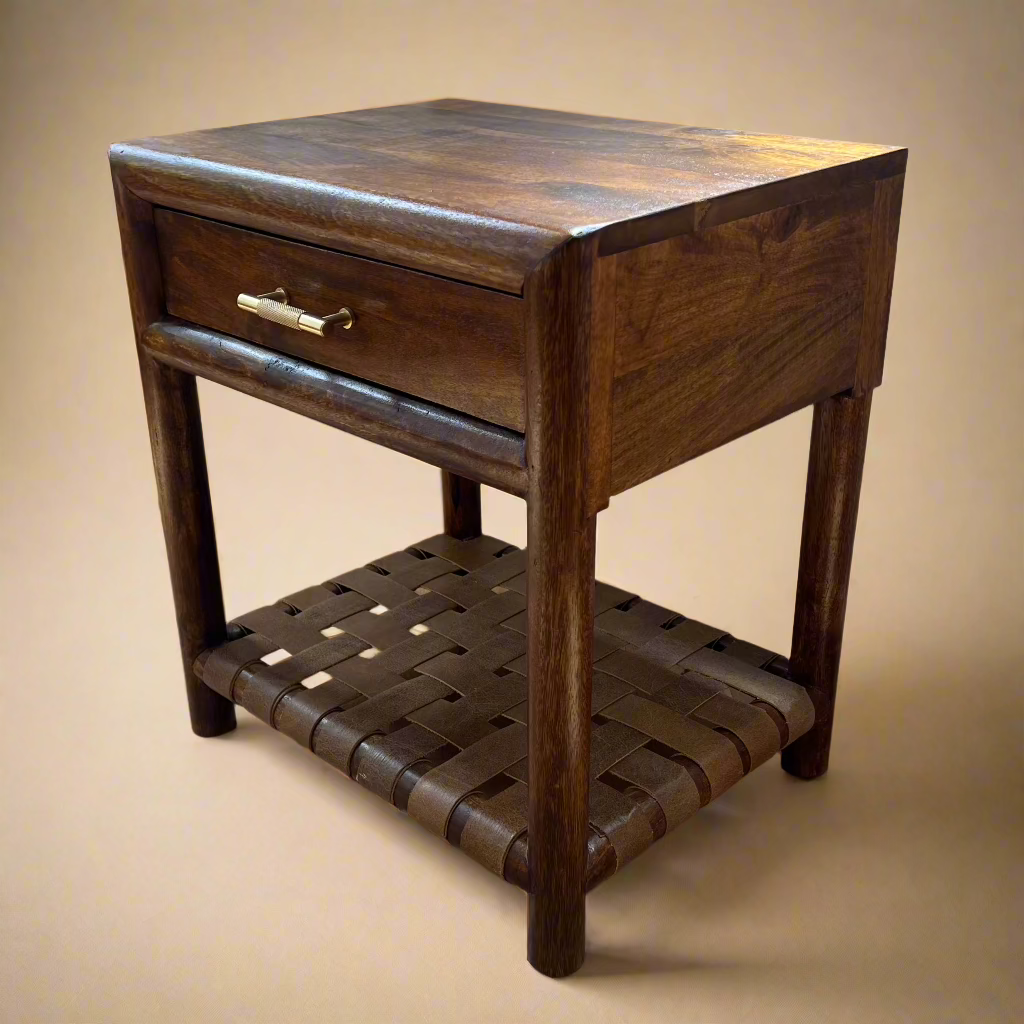 corner view of single drawer solid mango nightstand with gold handle and woven shelf