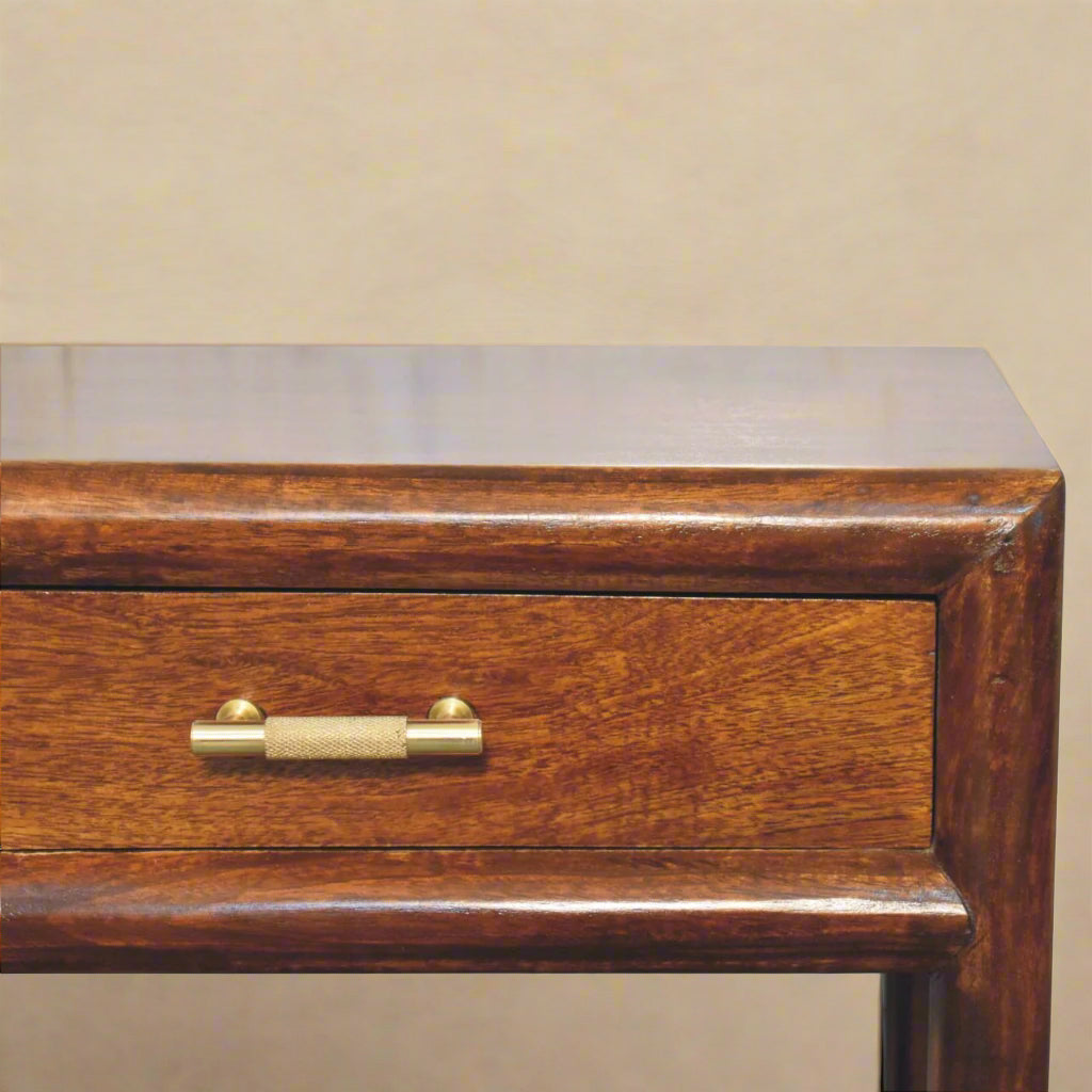 closeup of single shelf and gold handle on solid mango nightstand showing wood grain patterning