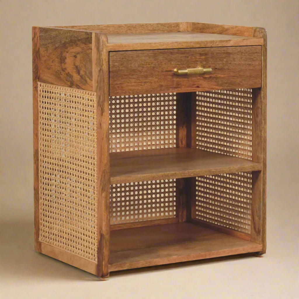 quarter view of solid mango two shelf one drawer nightstand showing rattan side profile natural wood patterning