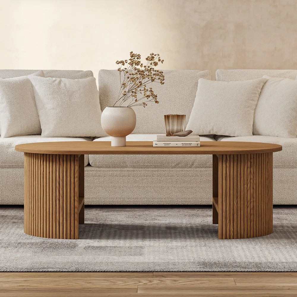 Fluted Oval coffee table styled in front of a cream sofa. Showcasing the mud century modern style of the coffee table.