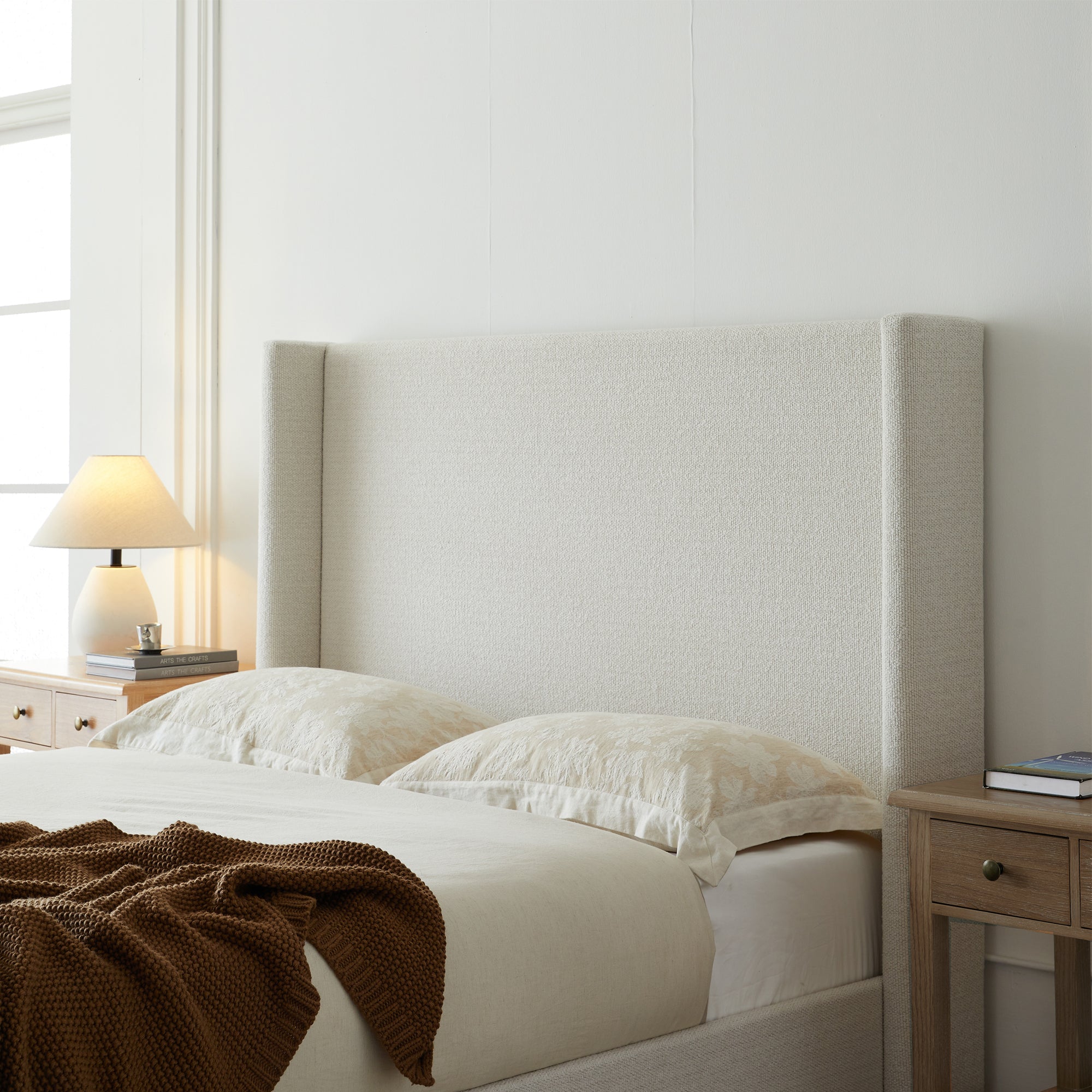Full studio shot of cream king bed frame on white background