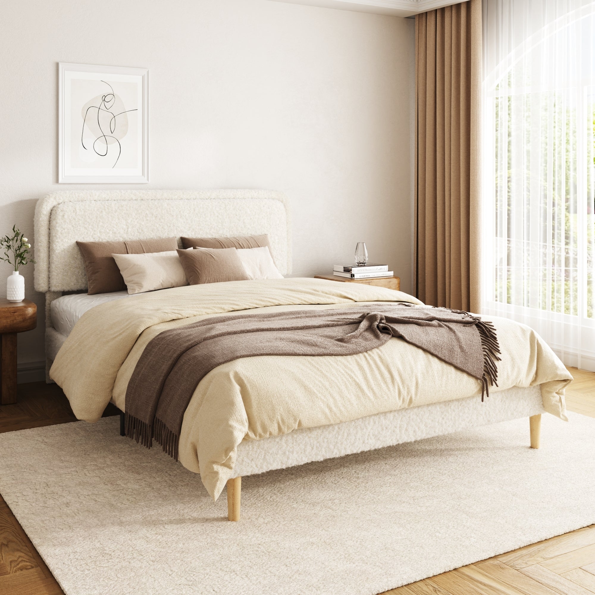 Angled view of the beige plush boucle platform bed in a bright bedroom with a brown throw and wood nightstands