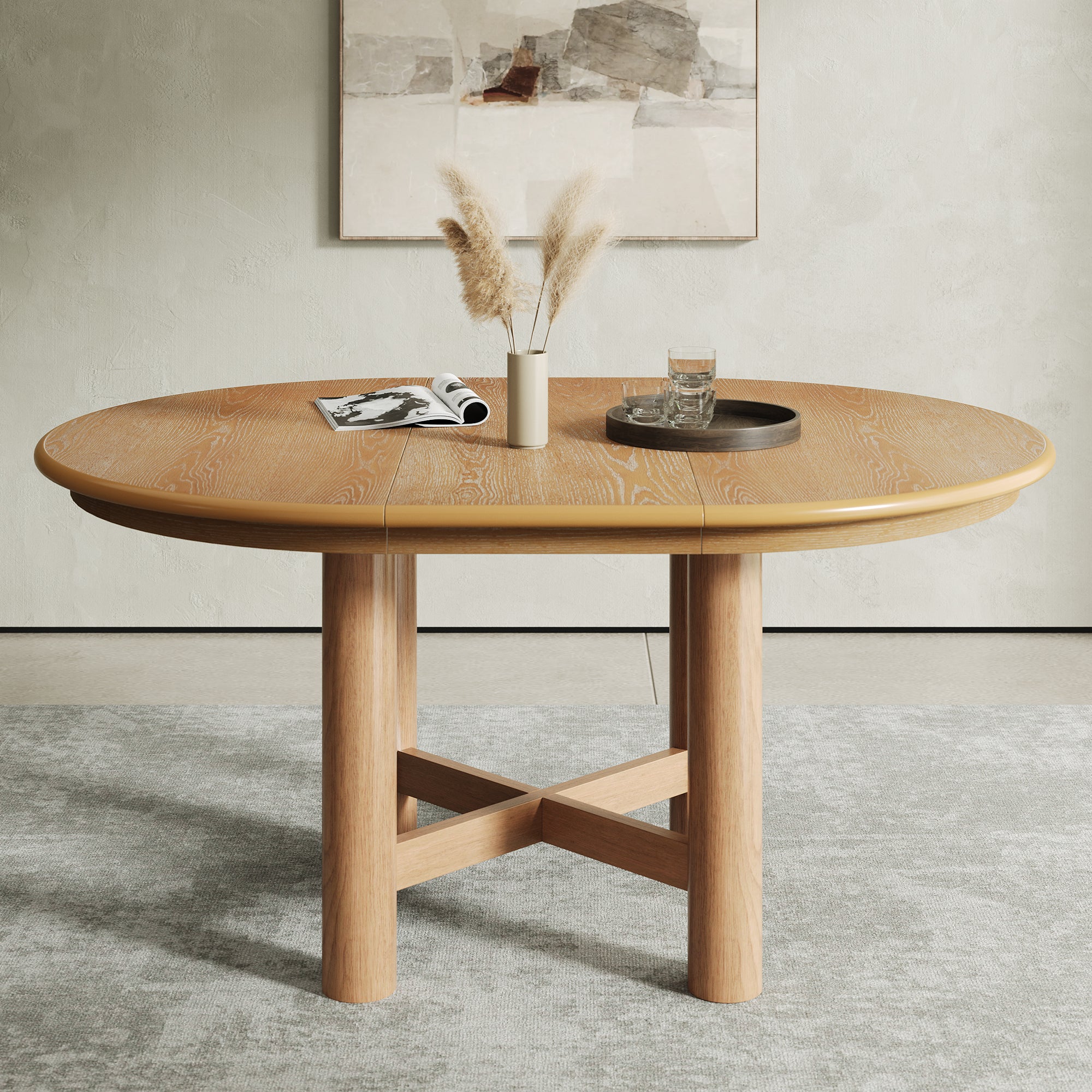 Oak-veneer oval extendable table extended, styled with pampas and a tray below abstract wall art