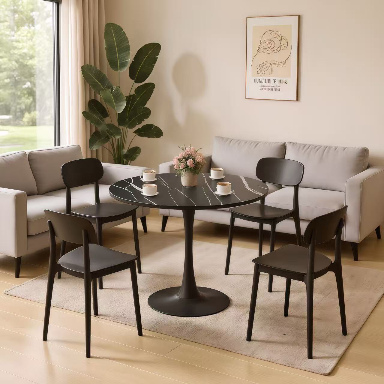 Black marble round table with four dark chairs in a beige living room seating group