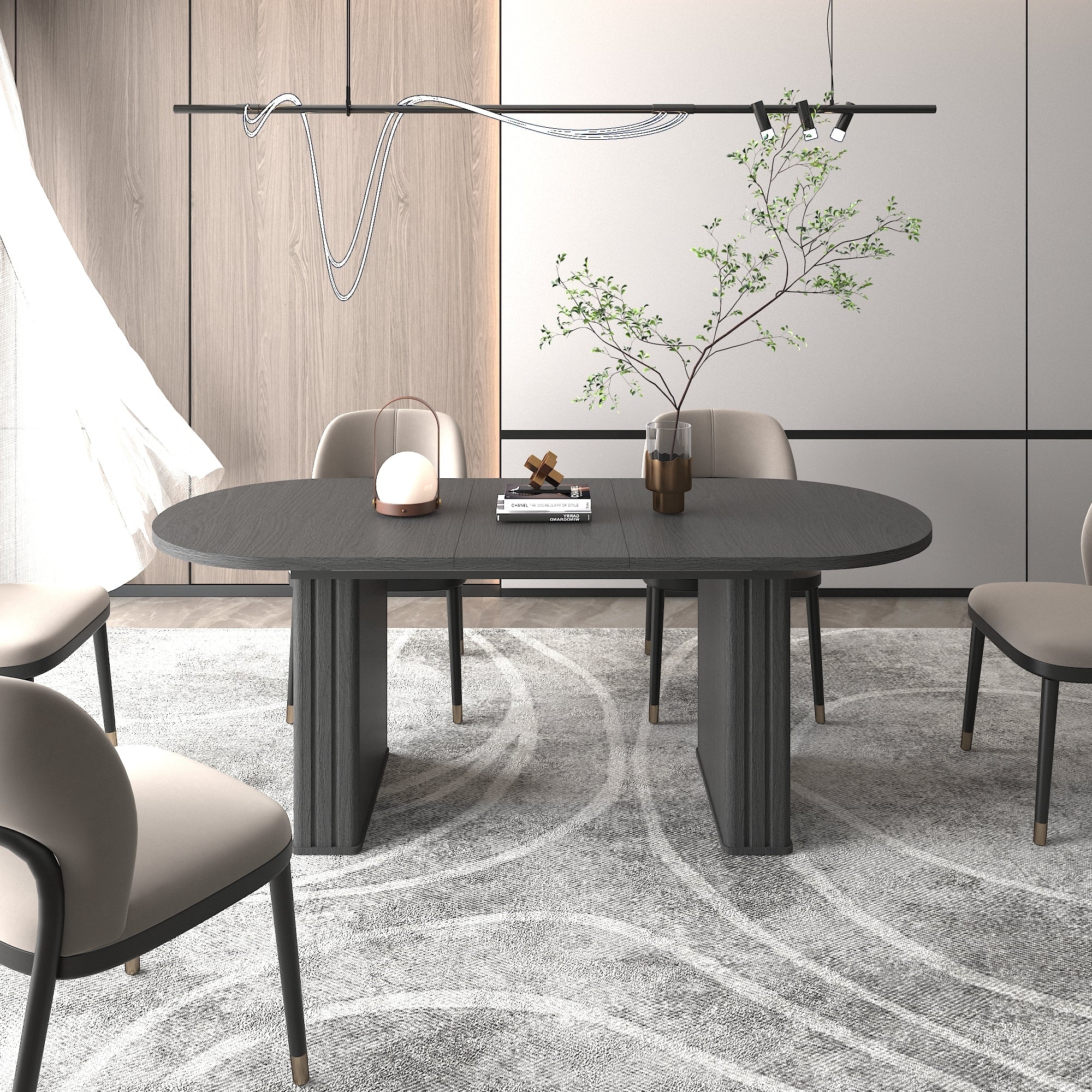 Black oval extendable dining table styled in a modern dining room with beige chairs and decor