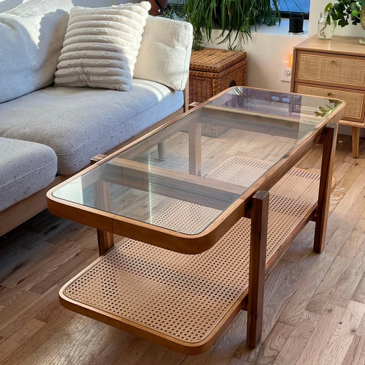 mid century living room with a acacia wood coffee table with rattan and tempered glass