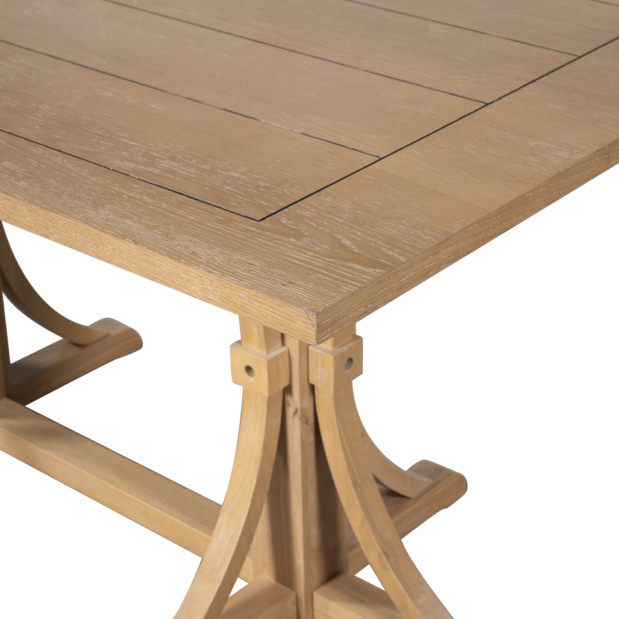Close-up of the tabletop corner and curved trestle base of the farmhouse dining table, white background