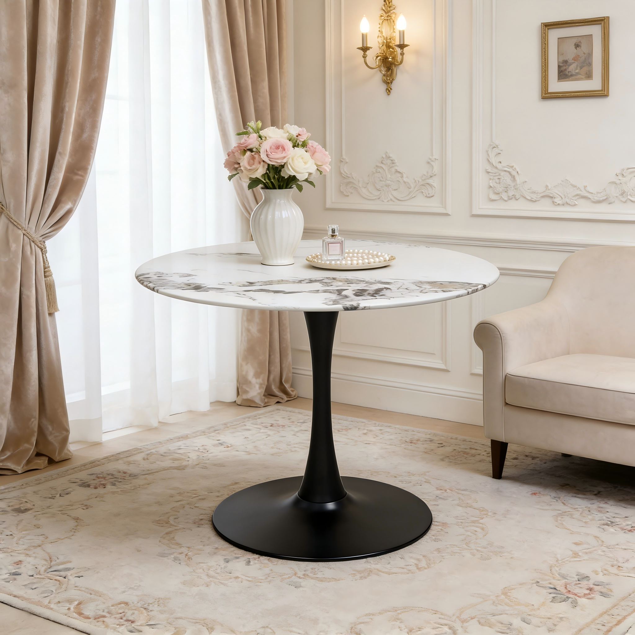 Faux marble tulip dining table with black base holding roses and perfume by a sofa