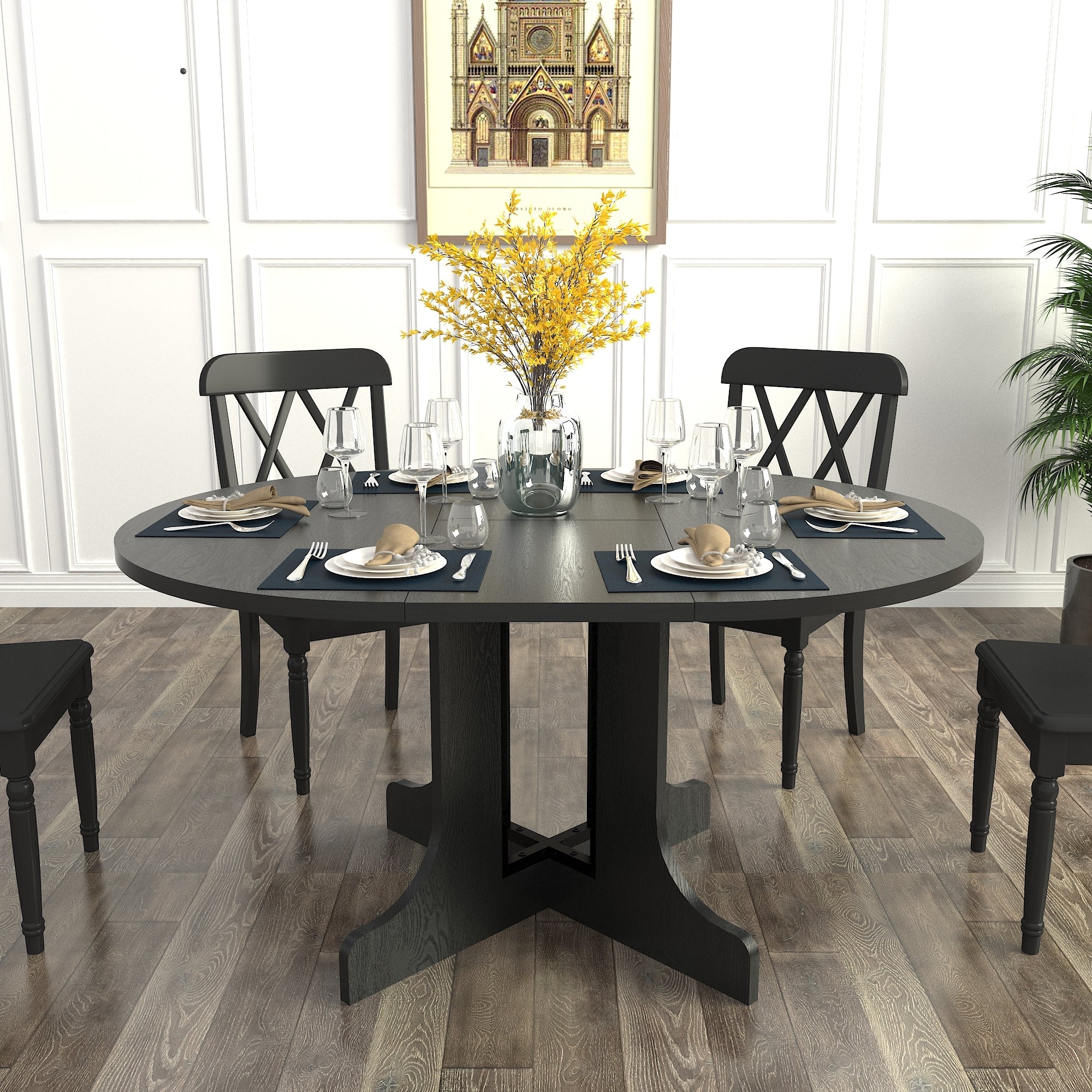 Oval black dining table set with plates and wine, yellow forsythia and black cross-back chairs