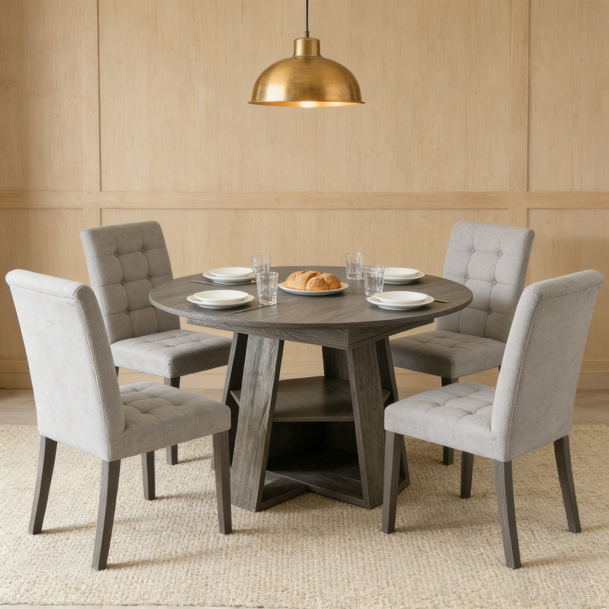 Styled dining room with the gray round table, four gray tufted chairs and a gold pendant