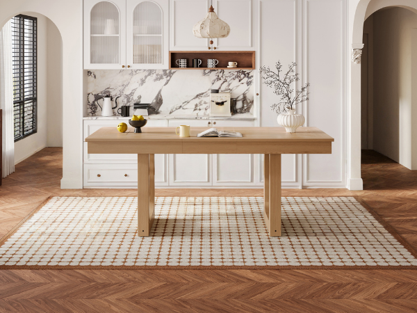 Front view of the natural oak extendable dining table in a styled room on a checkered rug