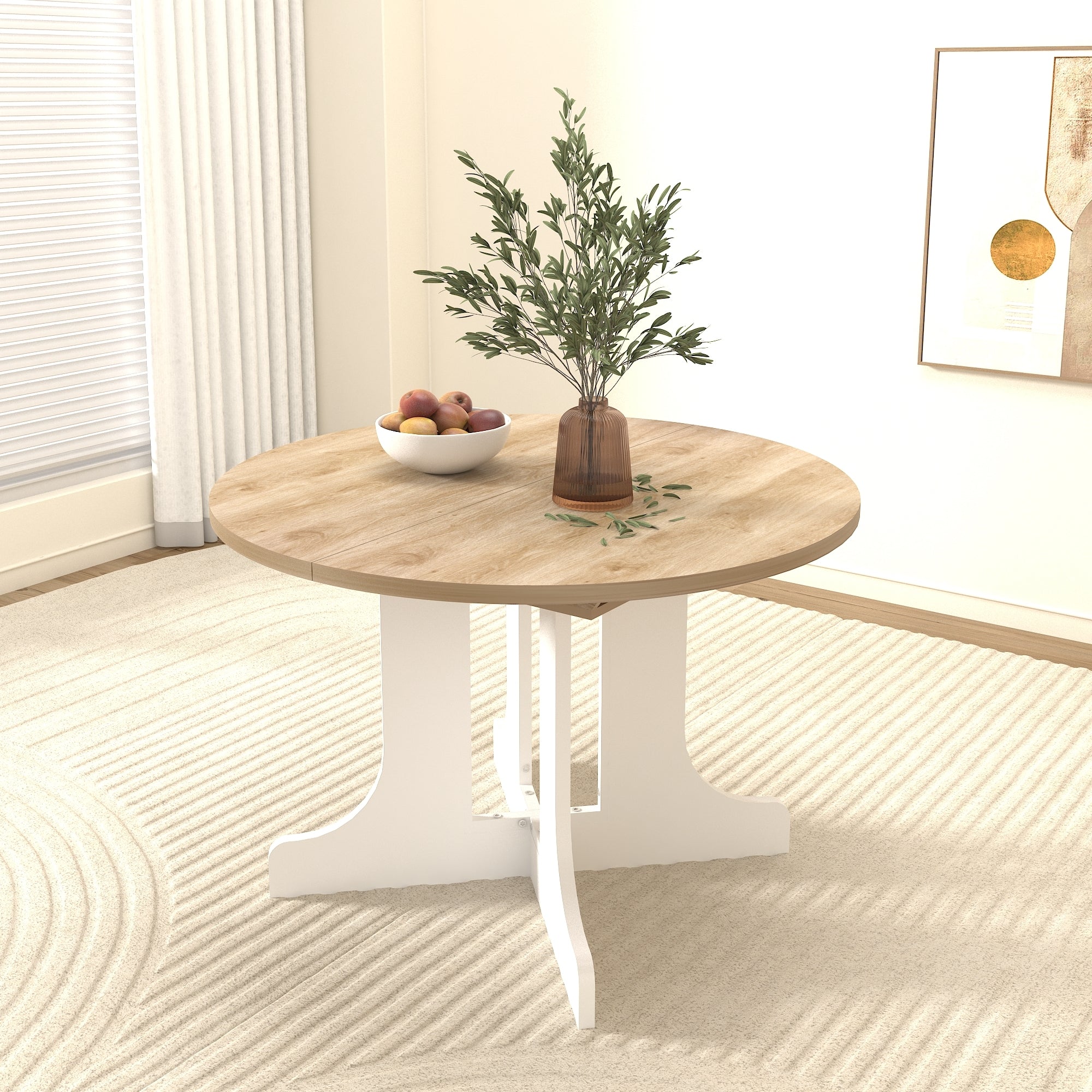 Round oak-top dining table with white pedestal base styled with a fruit bowl and olive branches