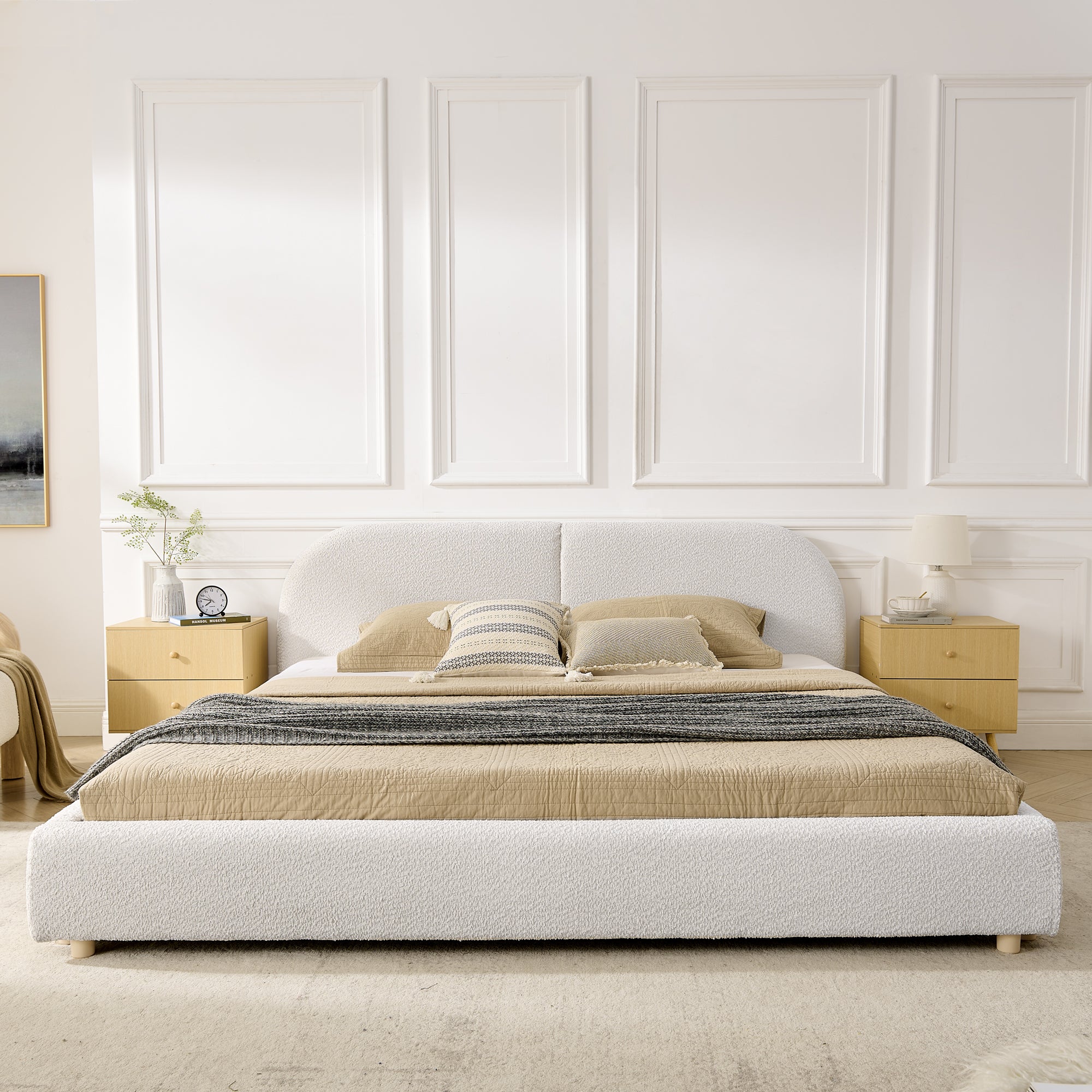 Front view of beige king bed with curved headboard between nightstands