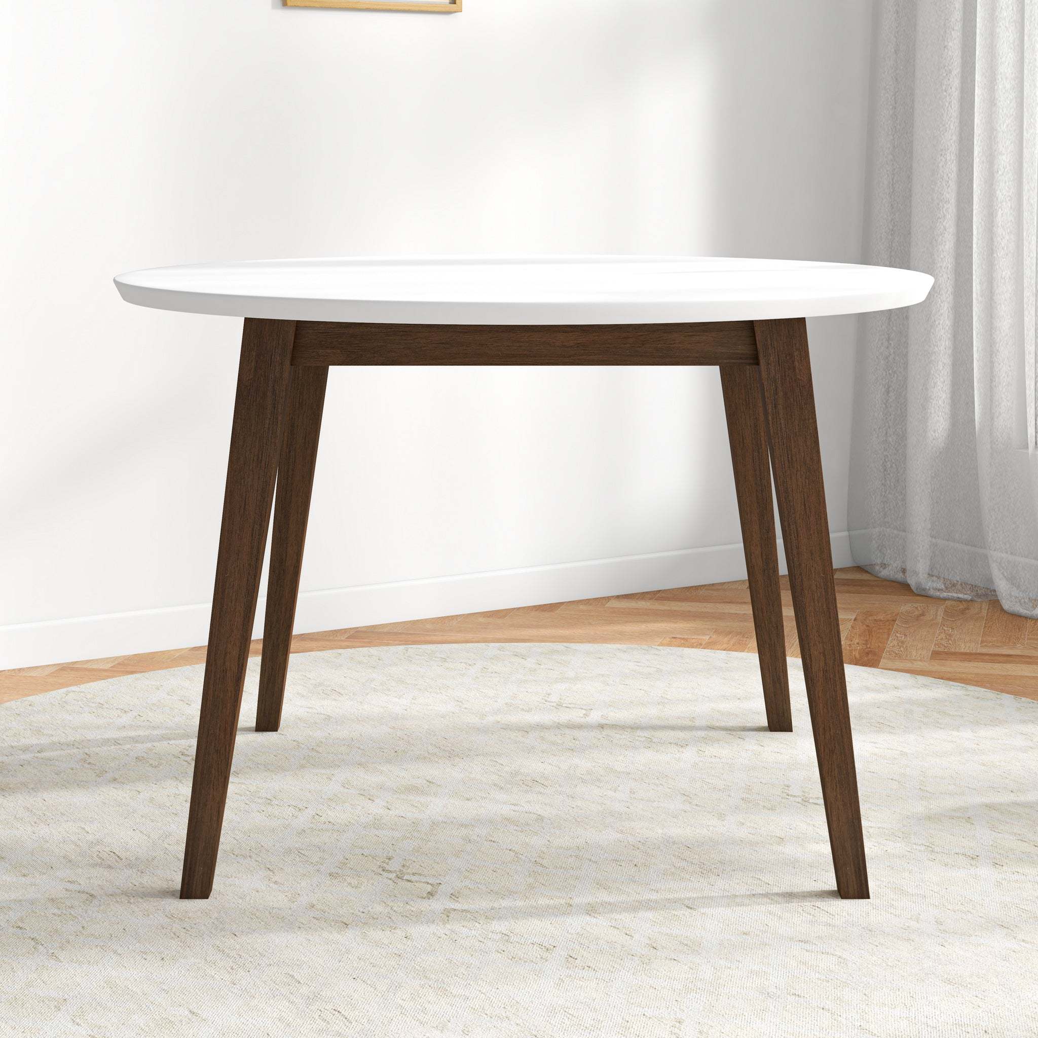 White round dining table, front view in a styled room with a window