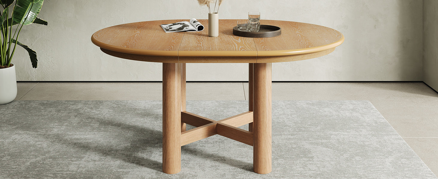 Round closed oak-veneer table with cream boucle chairs in a warm sunroom