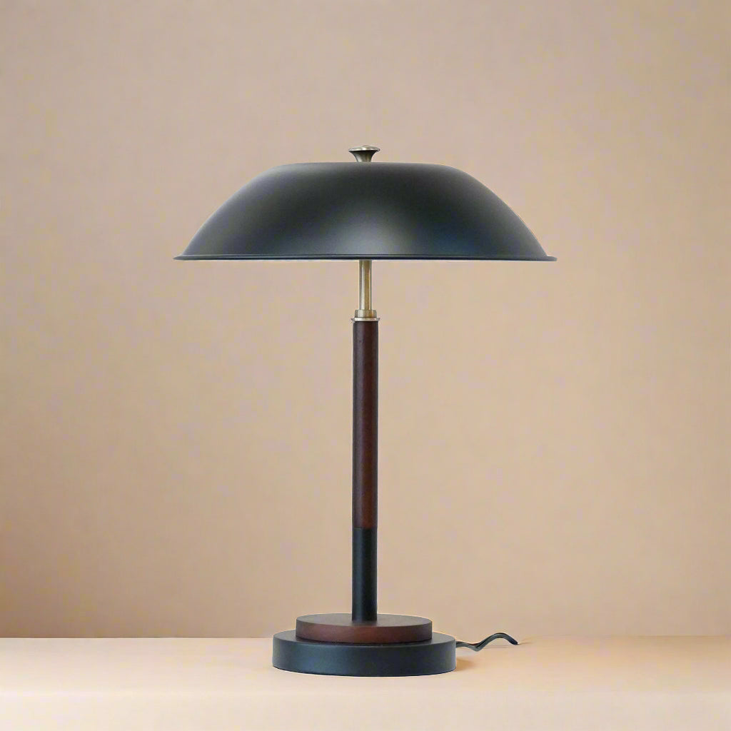 close up of a black table lamp turned off showing the black umbrella design and wood stem and base