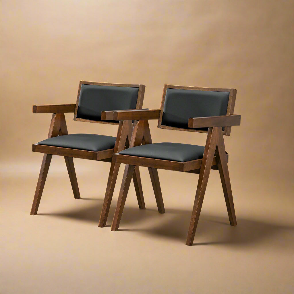 quarter shot of mid century modern dining chairs made of solid wood and black vegan leather