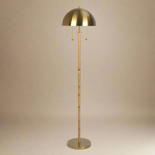 straight shot of boho rattan floor lamp with gold dome and rattan weaving up the stem