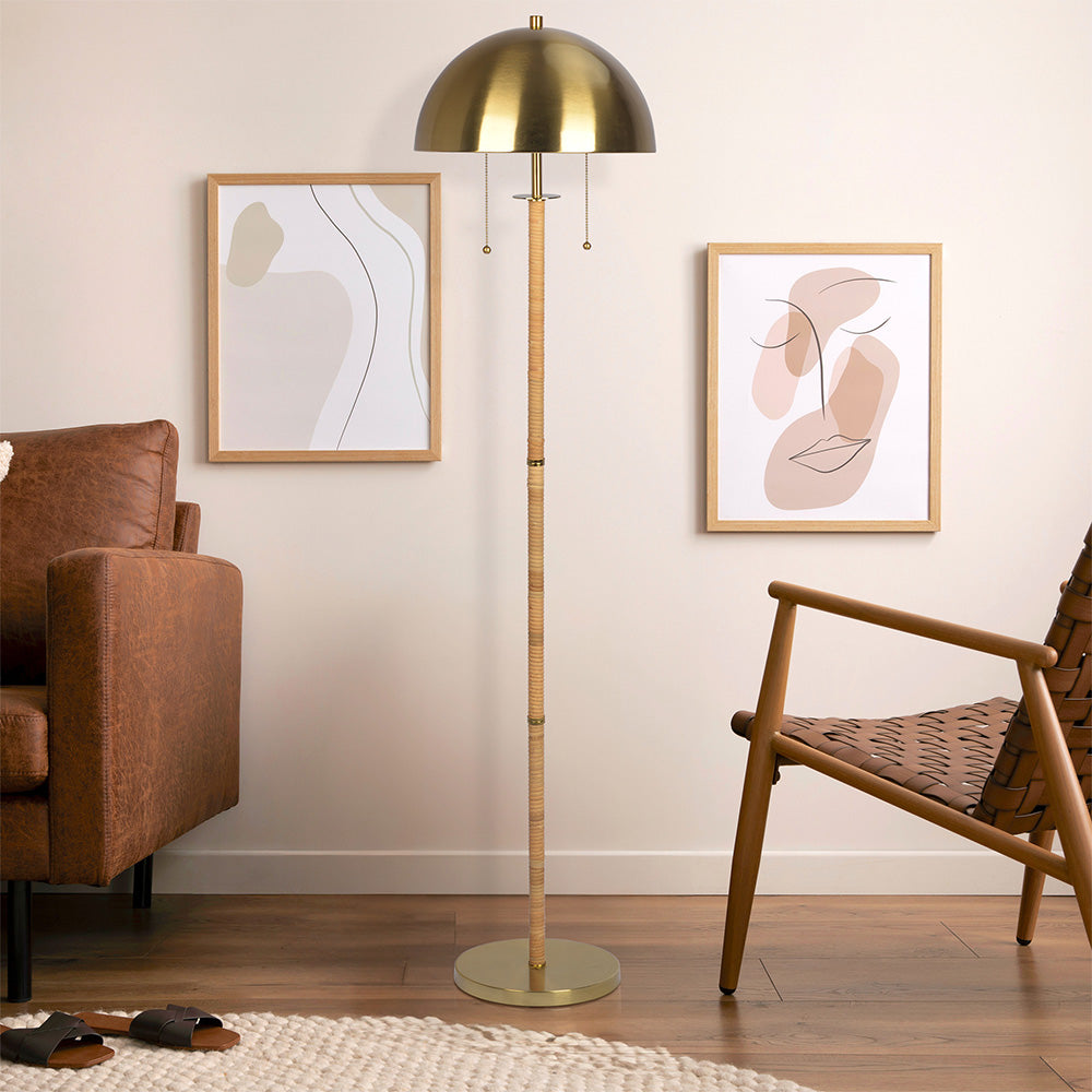 in room shot of boho rattan floor lamp in a mid century modern interior with wood and leather furniture around
