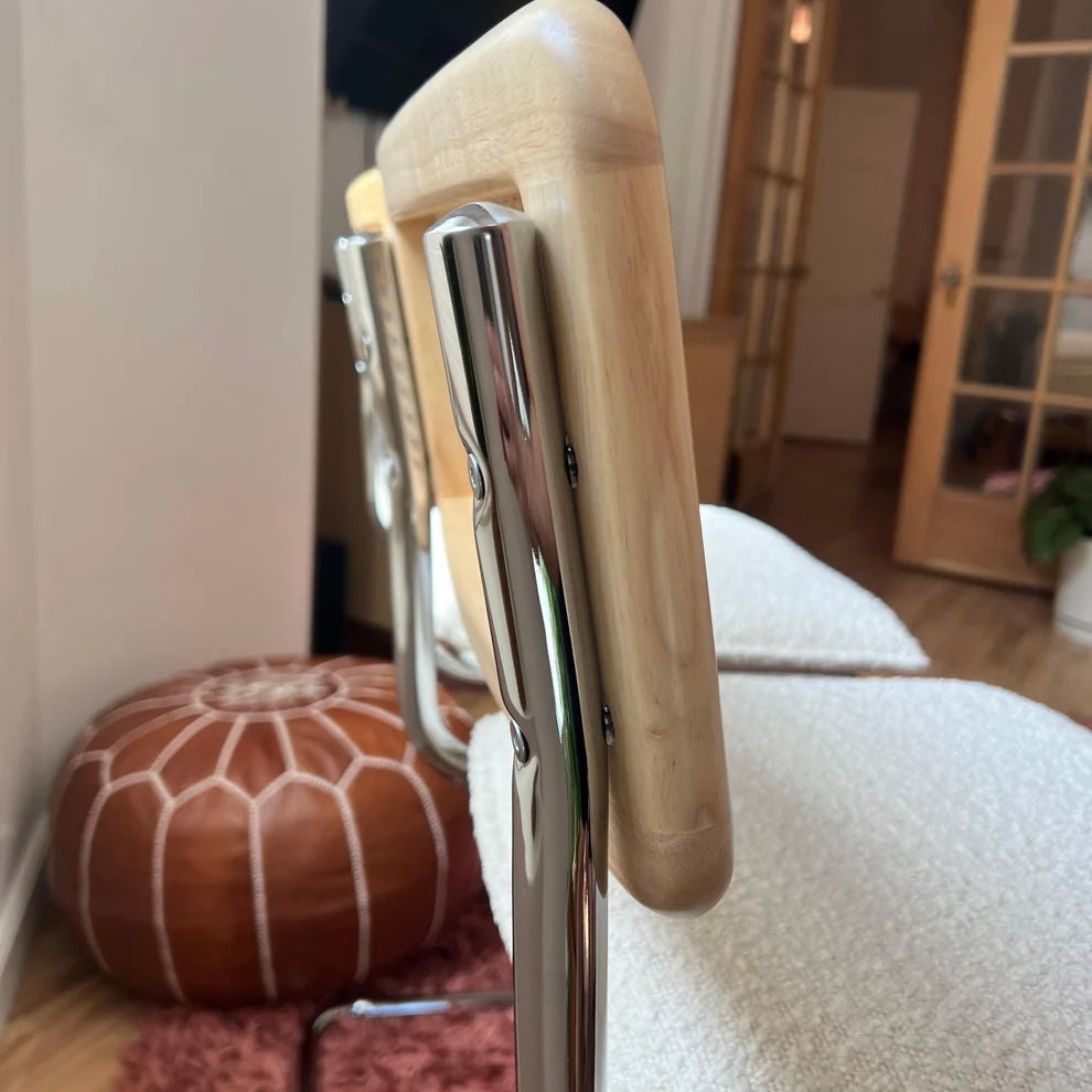 Midcentury Modern Counter Stools Set of 2 with white bouclé upholstery, rattan backs, and stainless steel legs in a kitchen.