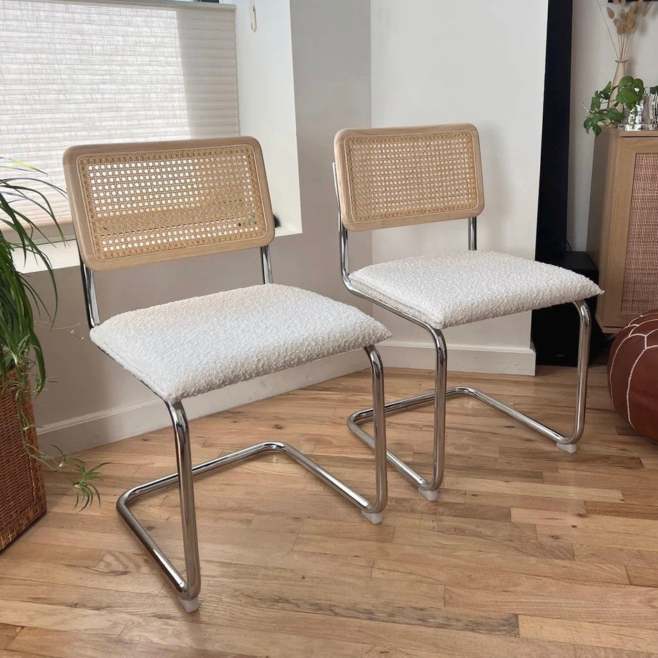 mcm dining chairs with white boucle seats solid wood and rattan backrests and stainless steel frames