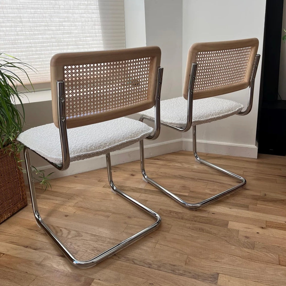 rear view of mid century modern dining chairs with solid wood back rests and rattan seat backs