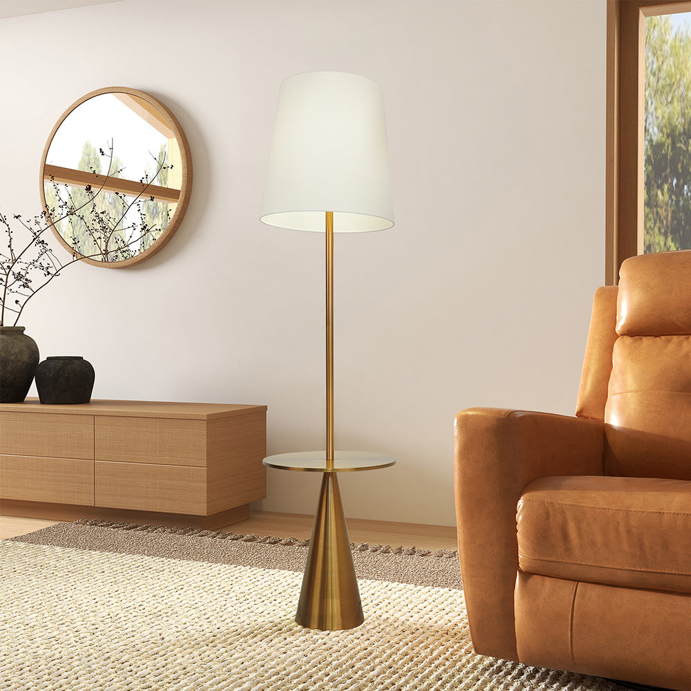 brass mid century floor lamp in a modern interior with the light on and warm light coming from under the shade