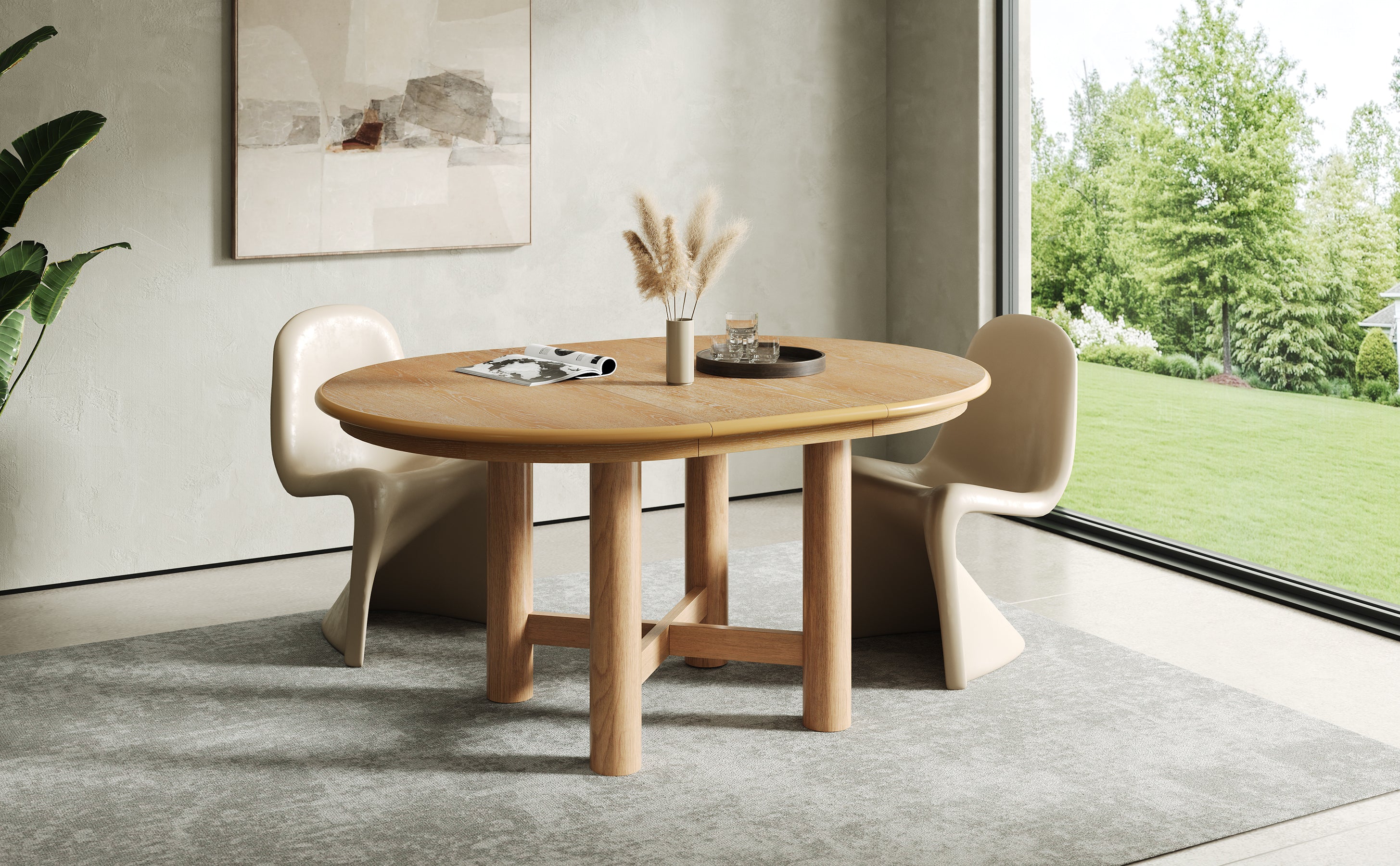 Front lifestyle view of the extended oval oak table with cream chairs and garden view