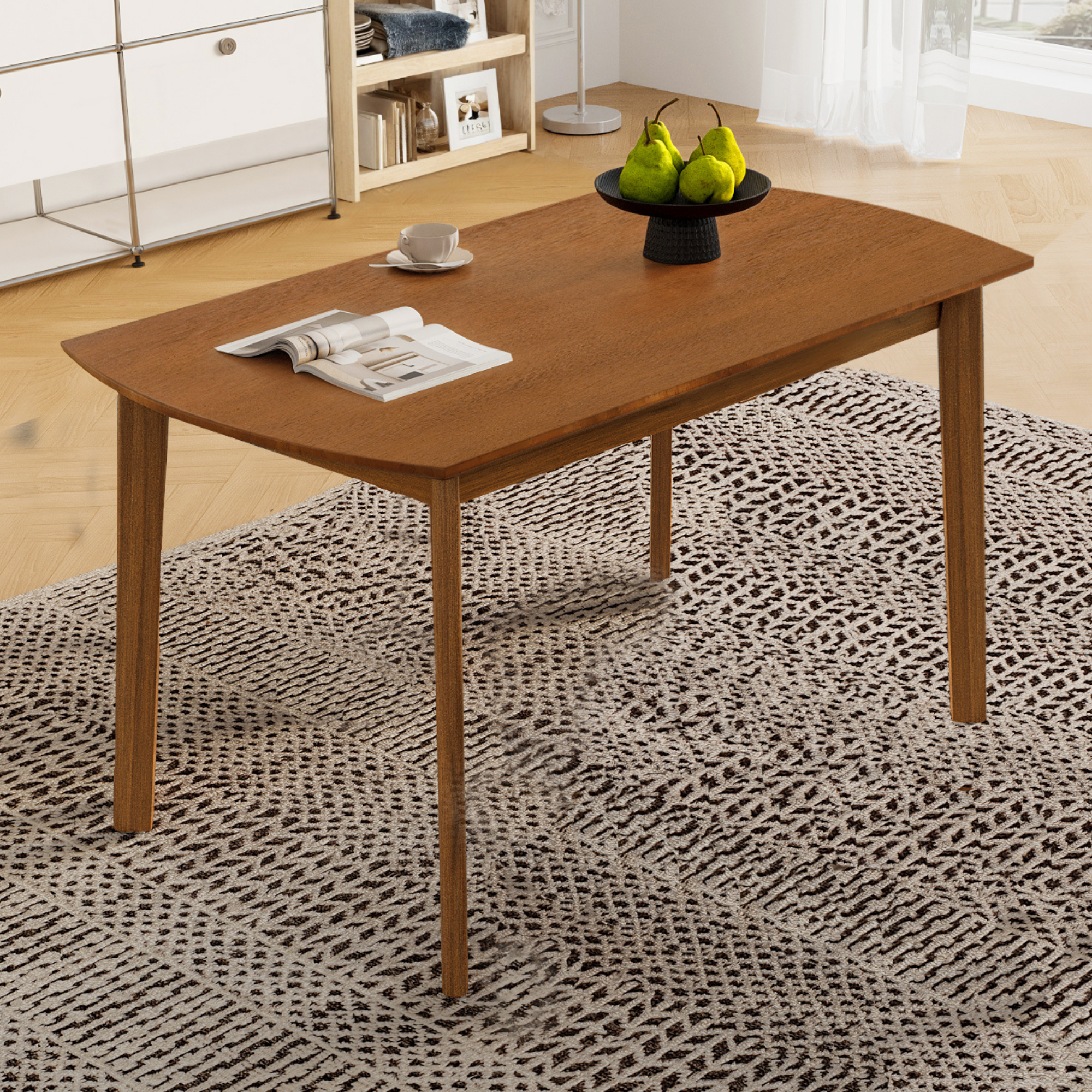 Brown mid-century dining table styled on a patterned rug with pears, cup and magazine, overhead view