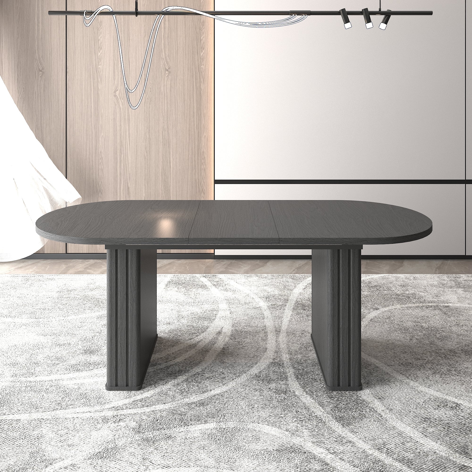 Front view of the black oval extendable dining table showing the center leaf seam in a styled room