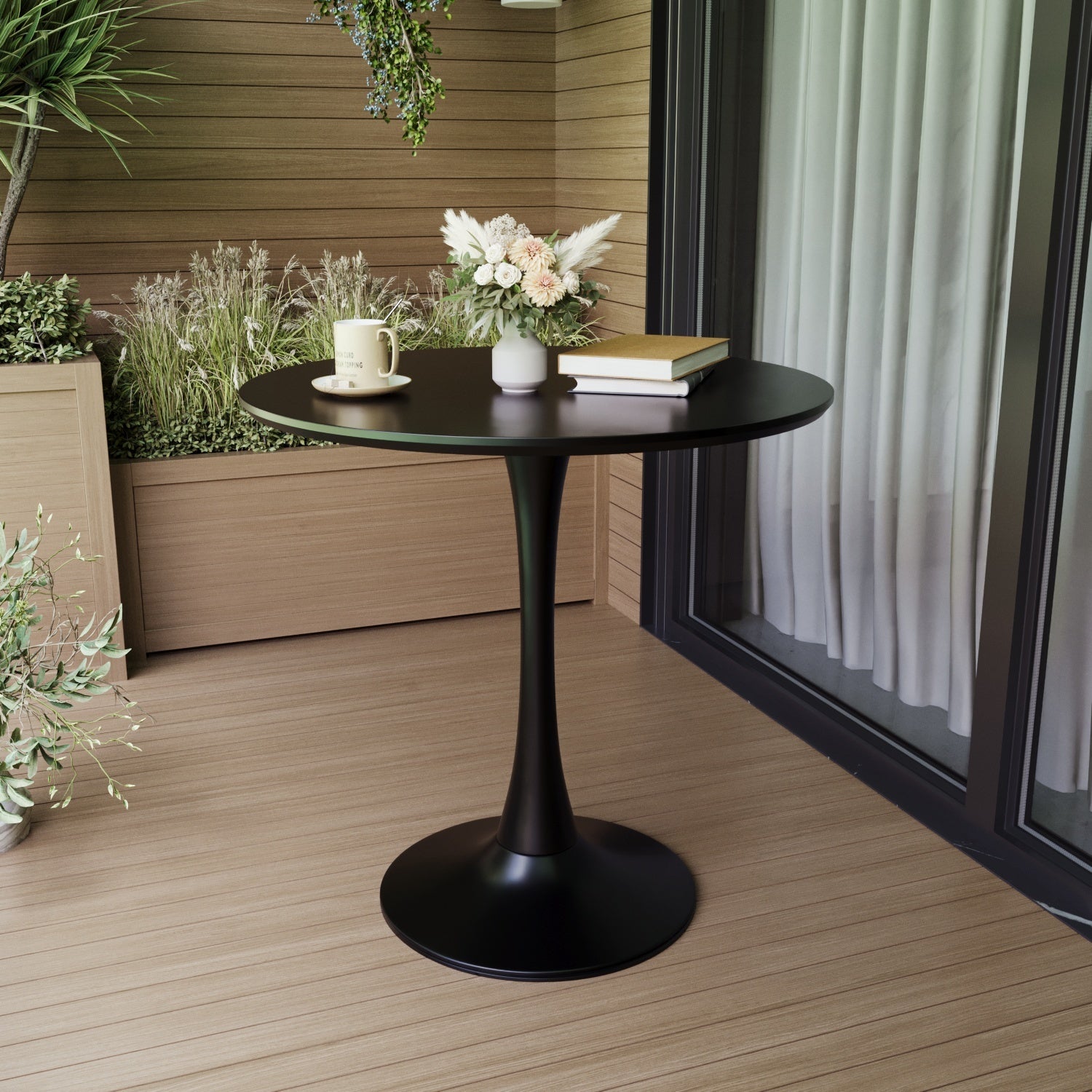 Black tulip dining table on a wood-paneled patio, set with a mug and flowers, three-quarter view