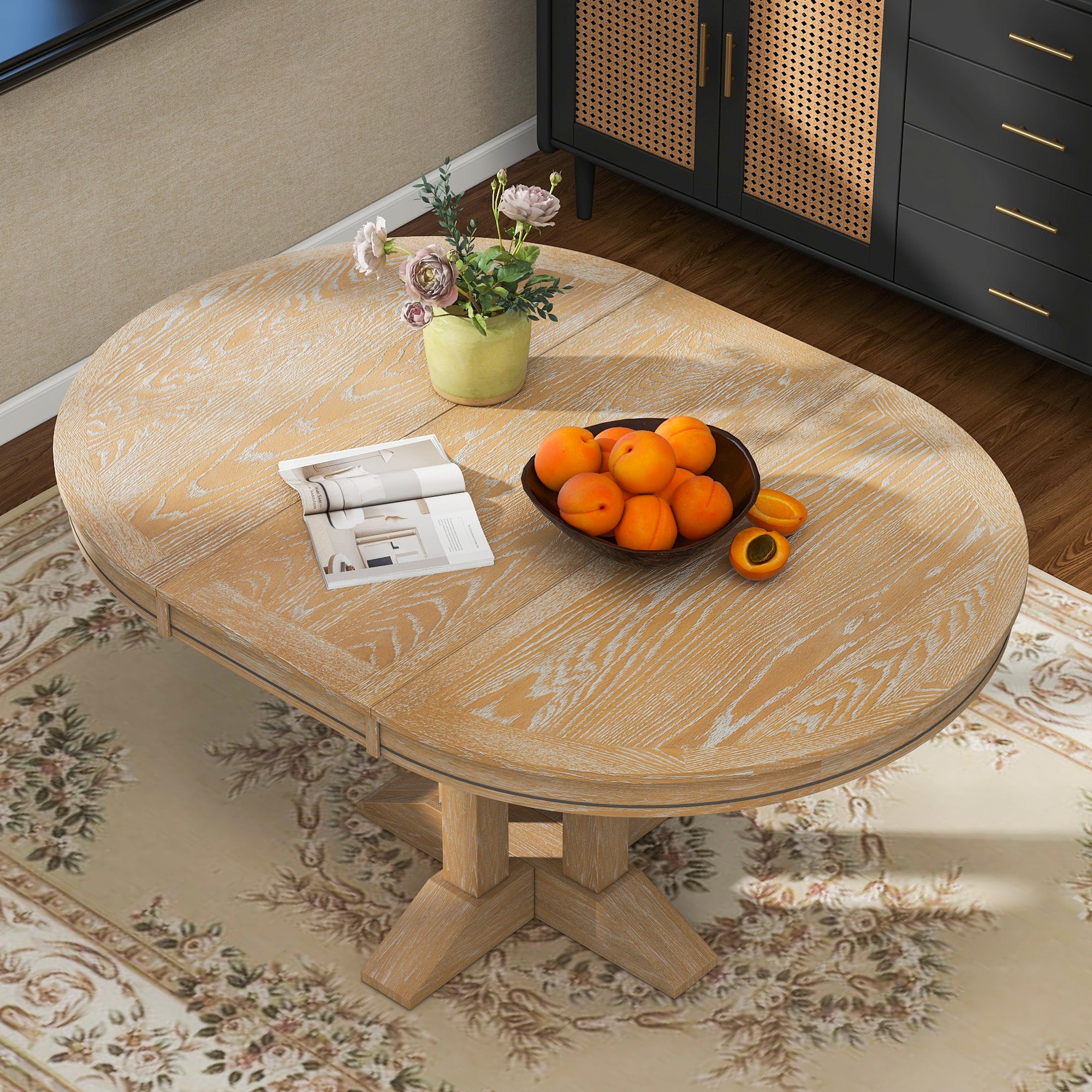 Overhead angled view of the natural oak oval-extended tabletop in a styled room