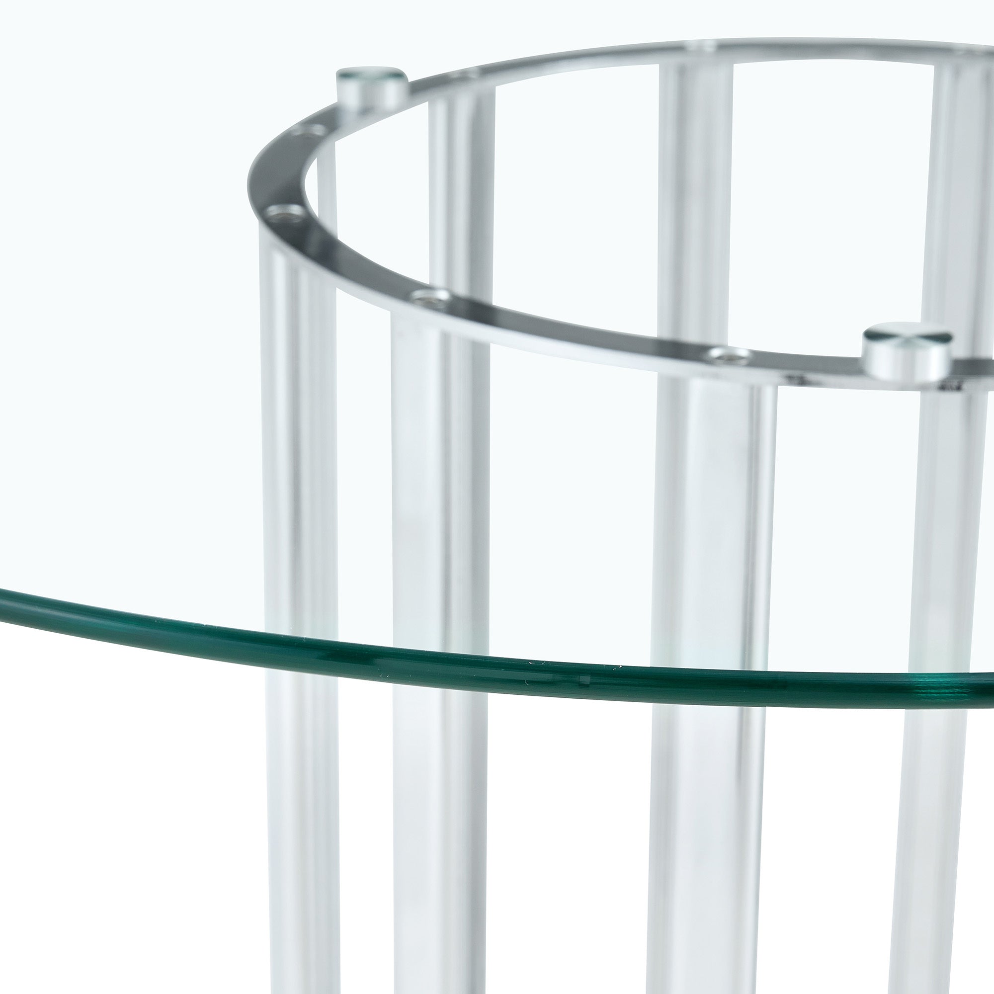 Close-up of the glass tabletop edge resting on a silver column base with suction cup fittings.
