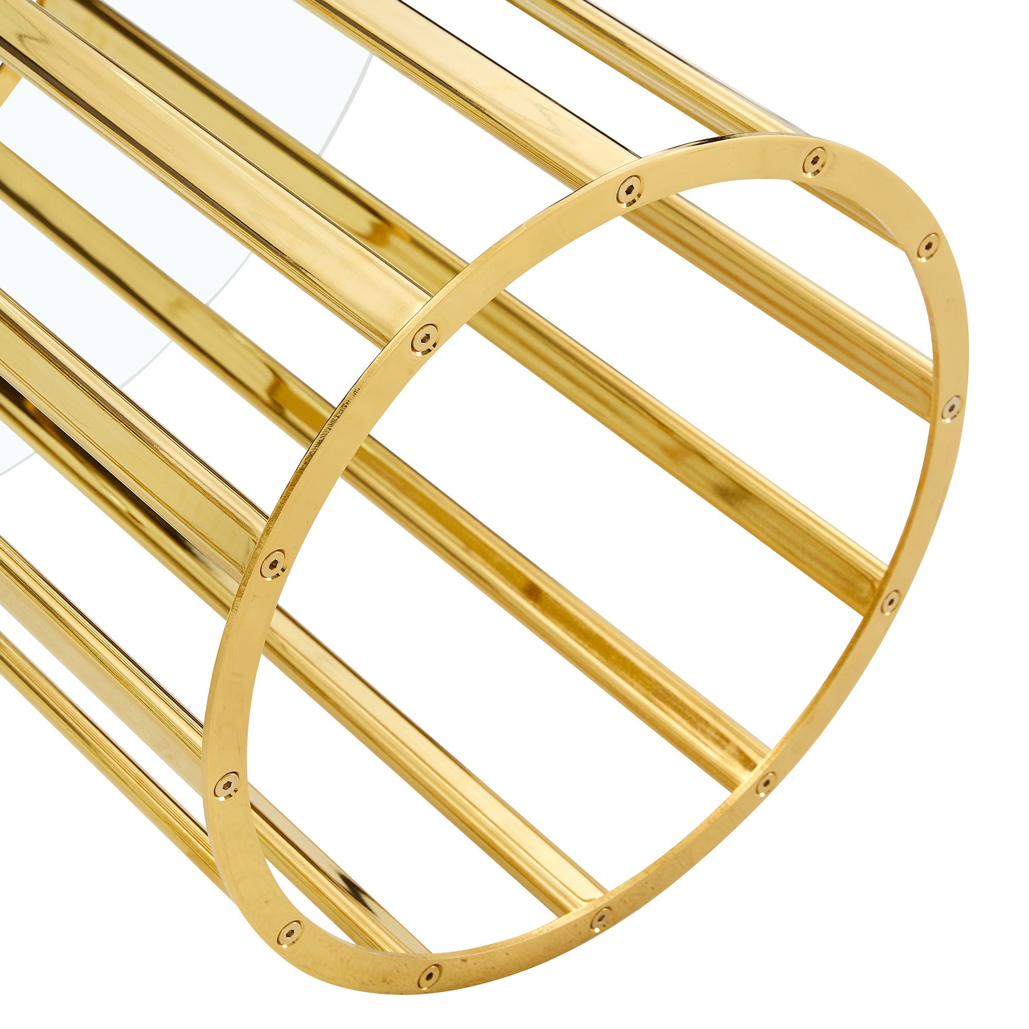 Angled close-up of a gold column base and the glass edge of the dining table on white