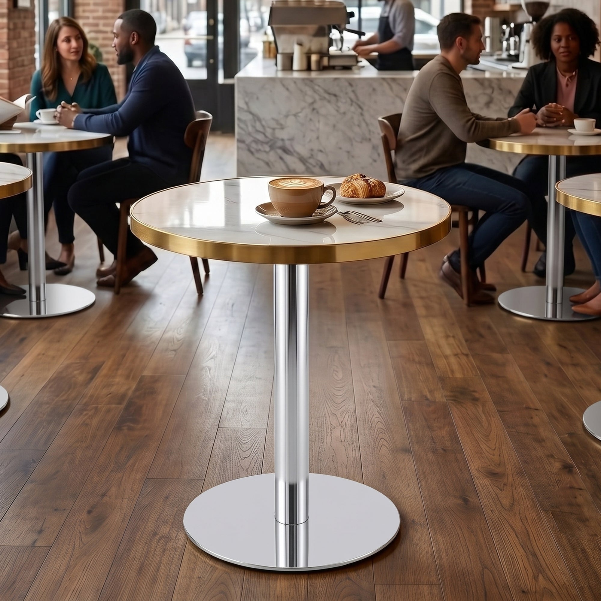 White faux marble bistro tables with gold trim in a busy cafe with seated guests