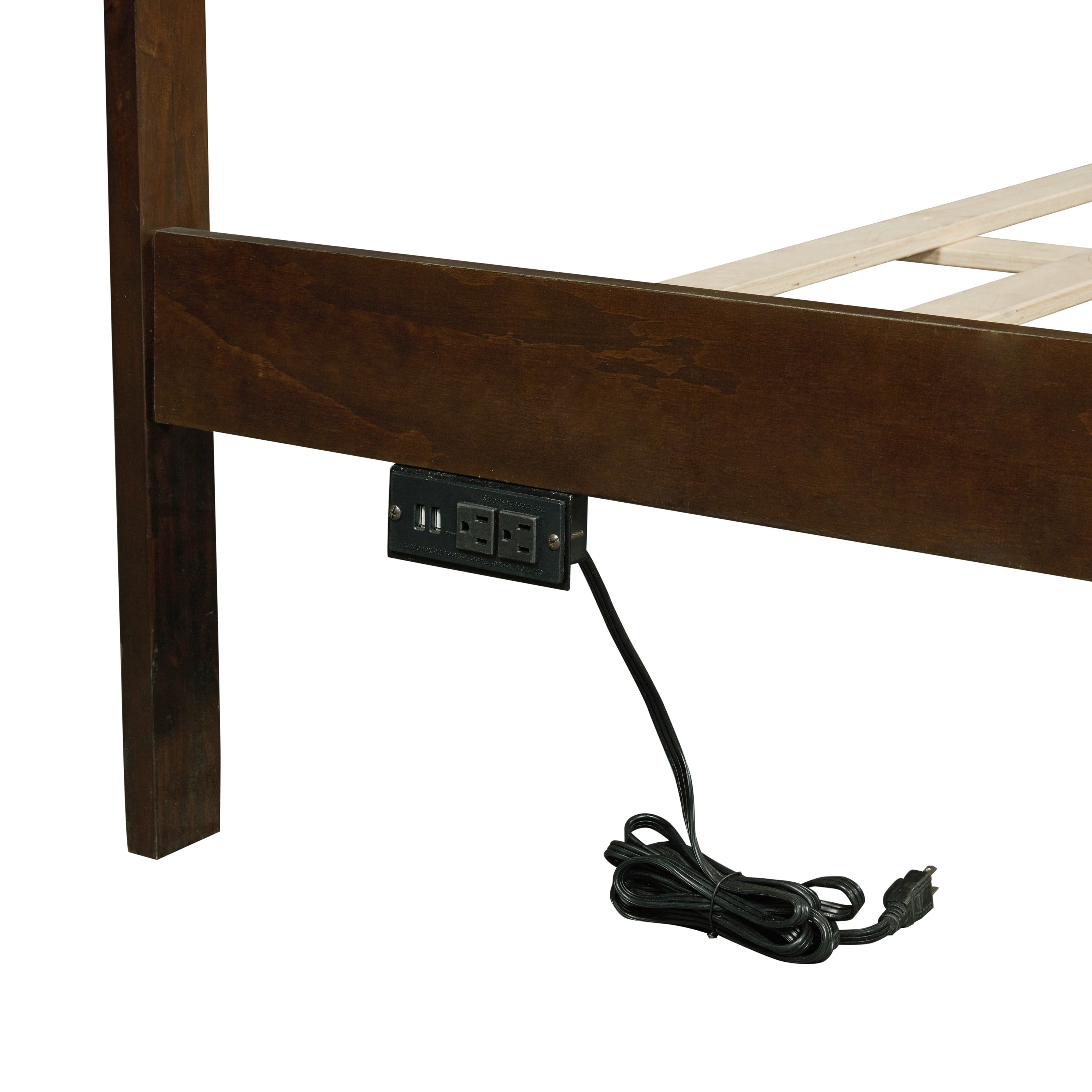 Close-up of the charging station with USB ports and power outlets and a cord on the bed rail